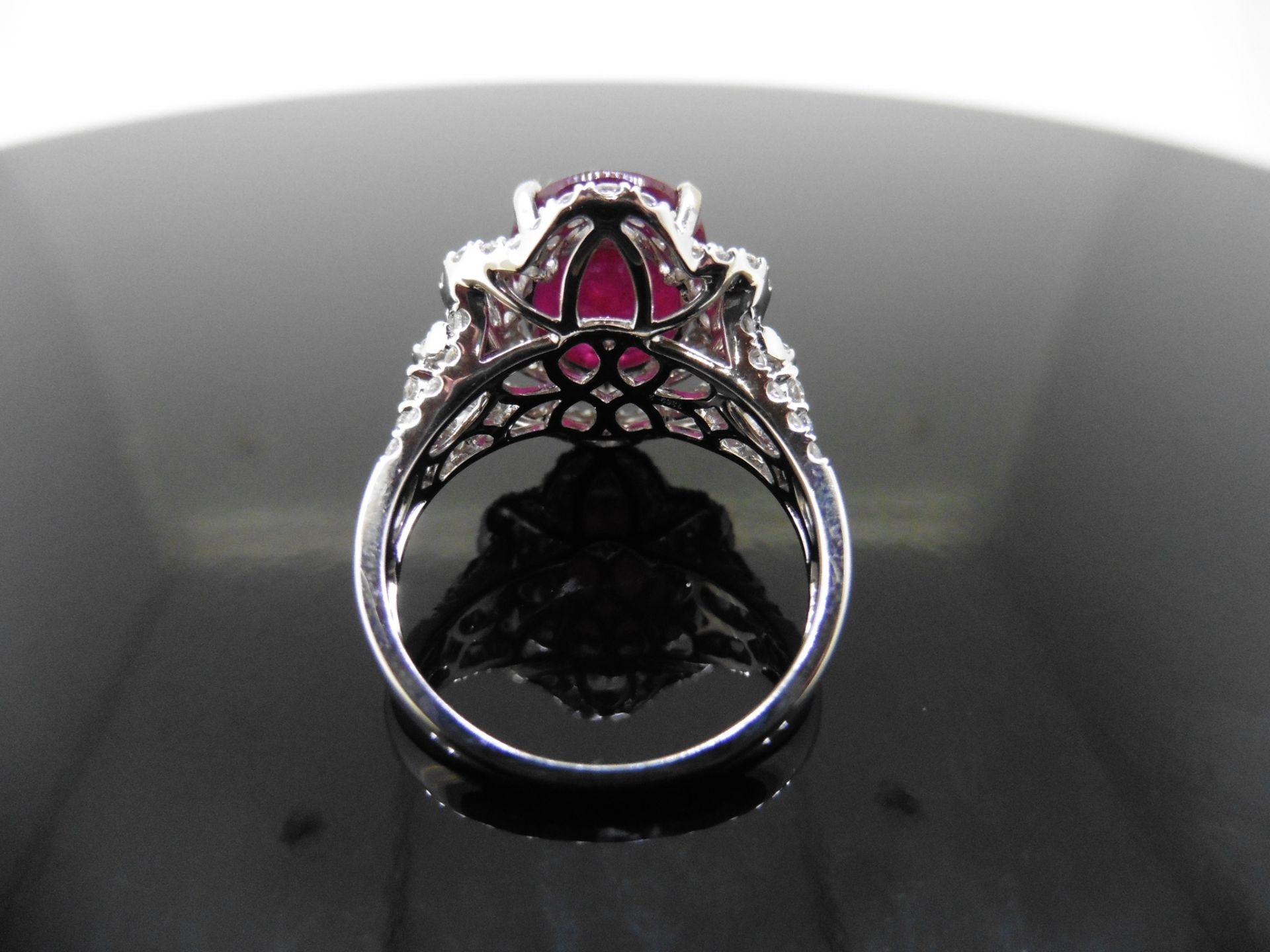 5.61ct Ruby and diamond fancy dress ring. Oval cut ruby ( treated ) set in a four claw setting - Image 2 of 6