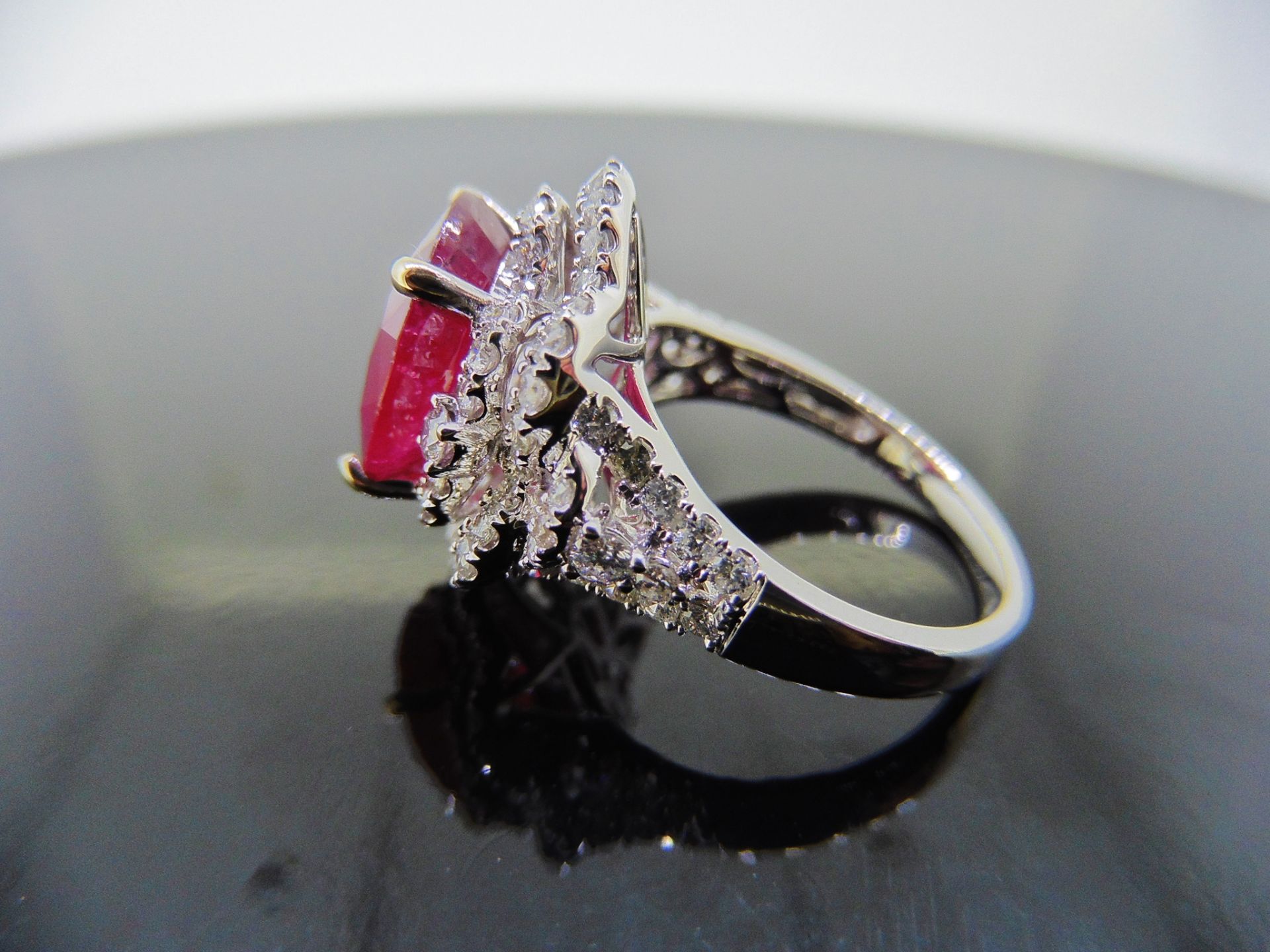 5.61ct Ruby and diamond fancy dress ring. Oval cut ruby ( treated ) set in a four claw setting - Image 3 of 6