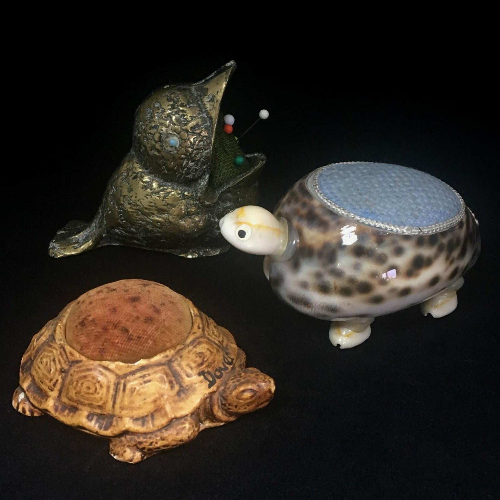 Antique collection of figural pin cushions to include a tortoise, a turtle and a bird. Includes free