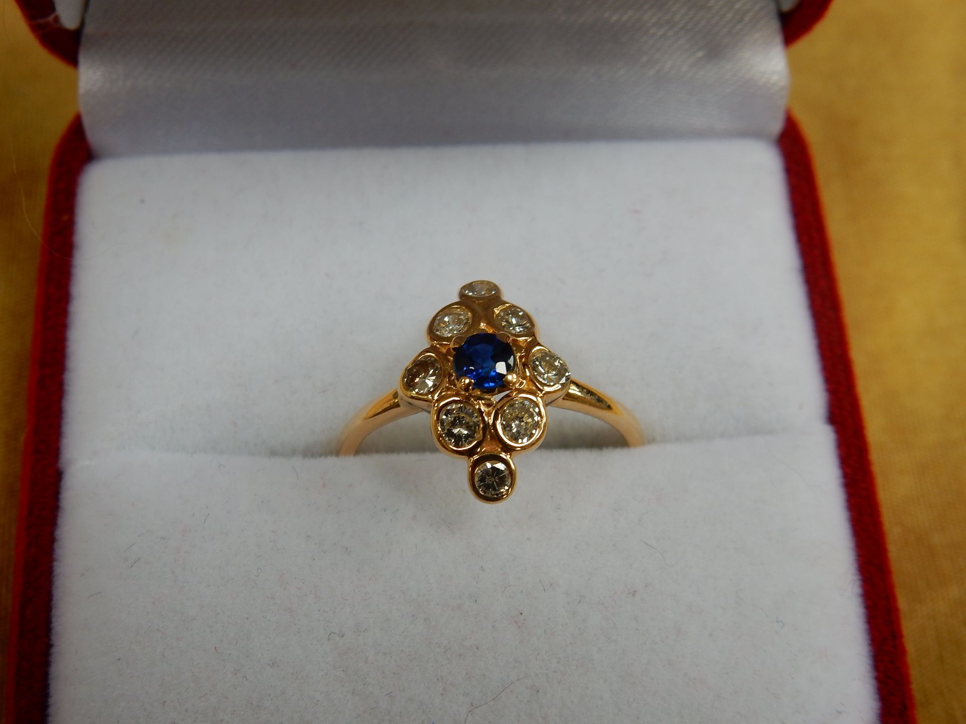 An 18 carat yellow gold sapphire and diamond marquise shaped cluster ring.