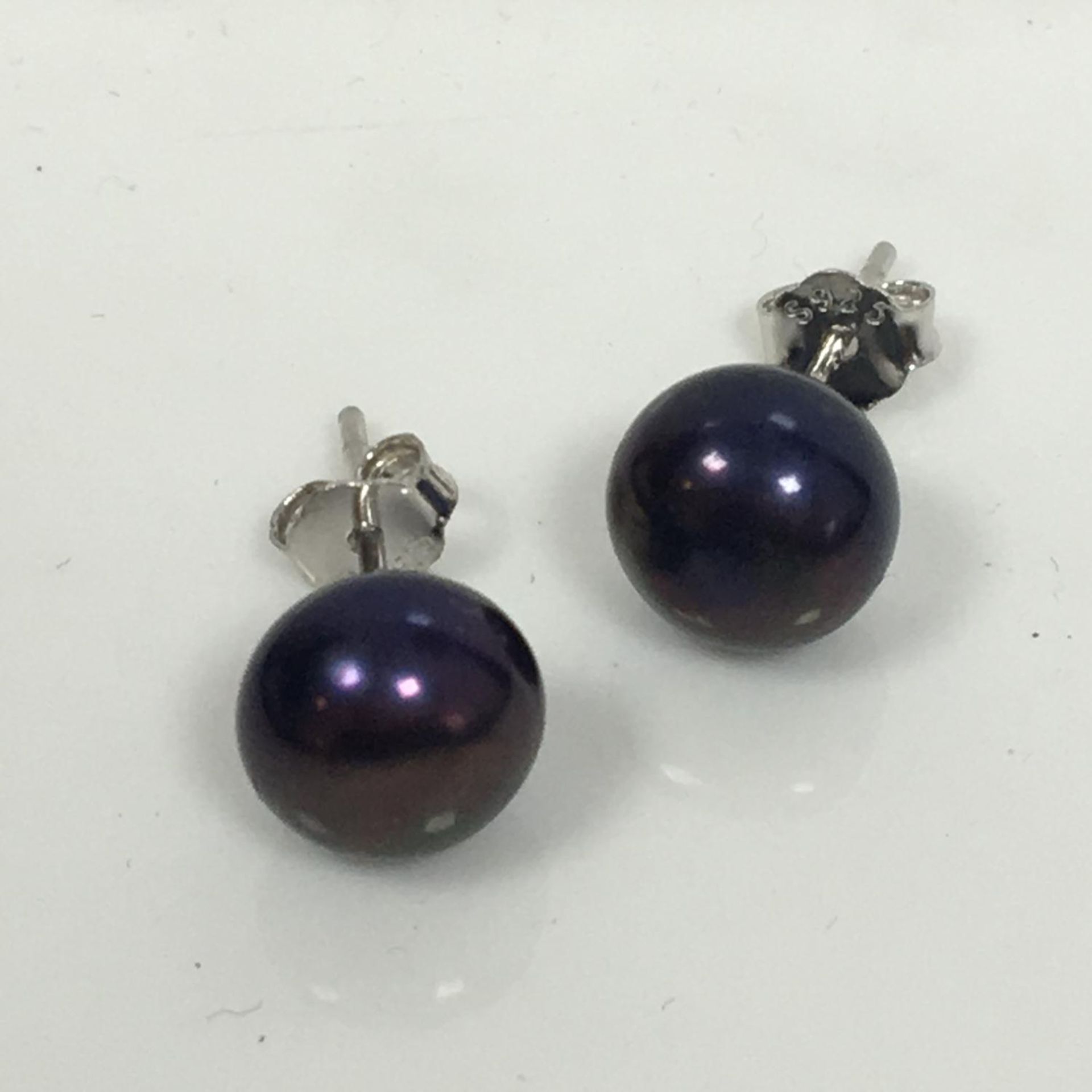 7mm freshwater black pearl stud earrings on 925 silver. Includes free UK delivery.