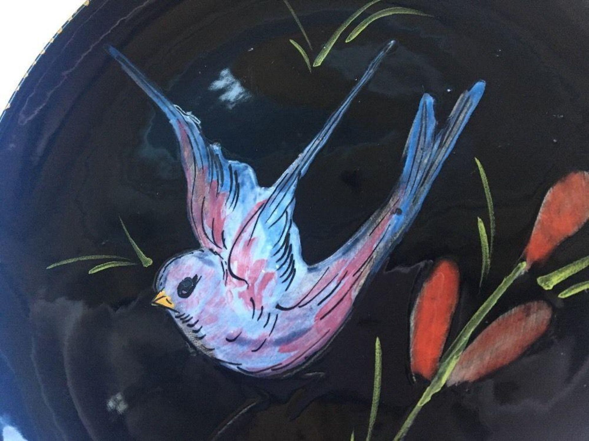 Signed studio art pottery handpainted bird black plate unknown indistinct maker. Measures 18cm