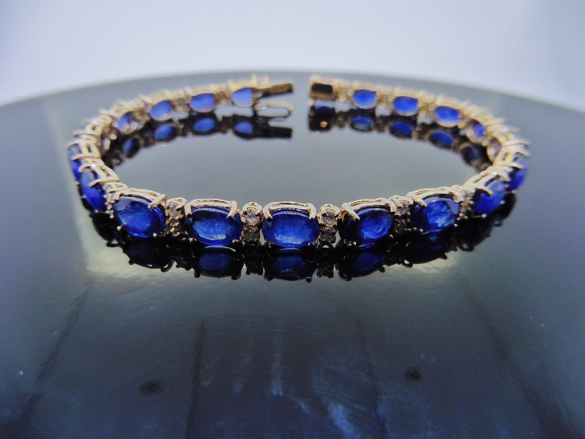18ct white gold Sapphire and diamond bracelet. Set with 7 x 5mm oval cut treated sapphires, total