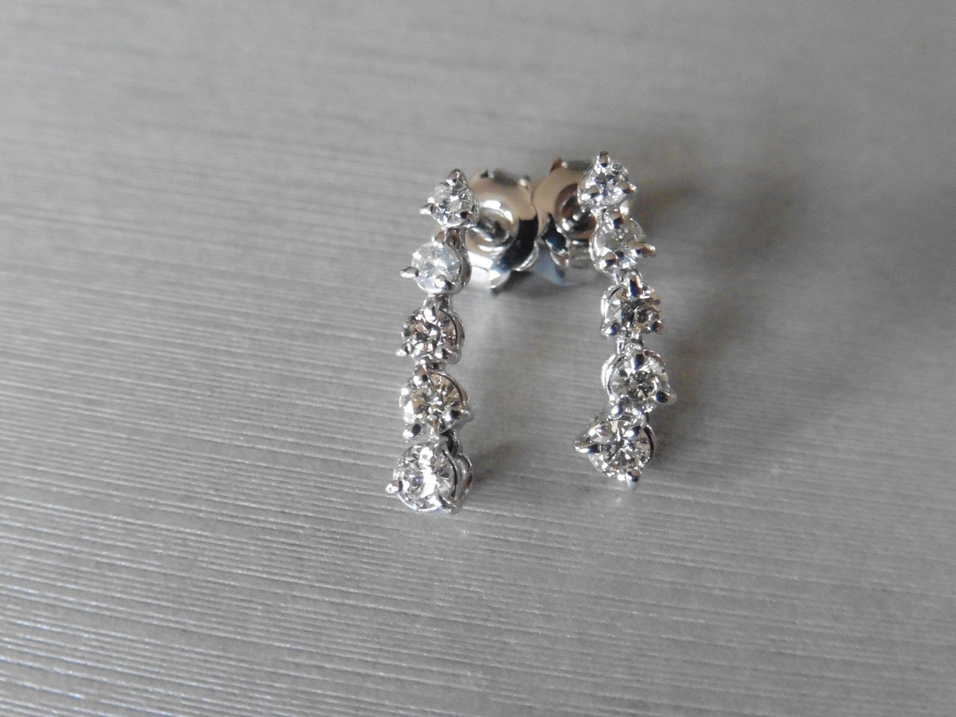 0.70ct diamond drop earrings. Each set with 5 graduated brilliant cut diamonds. I colour, si2