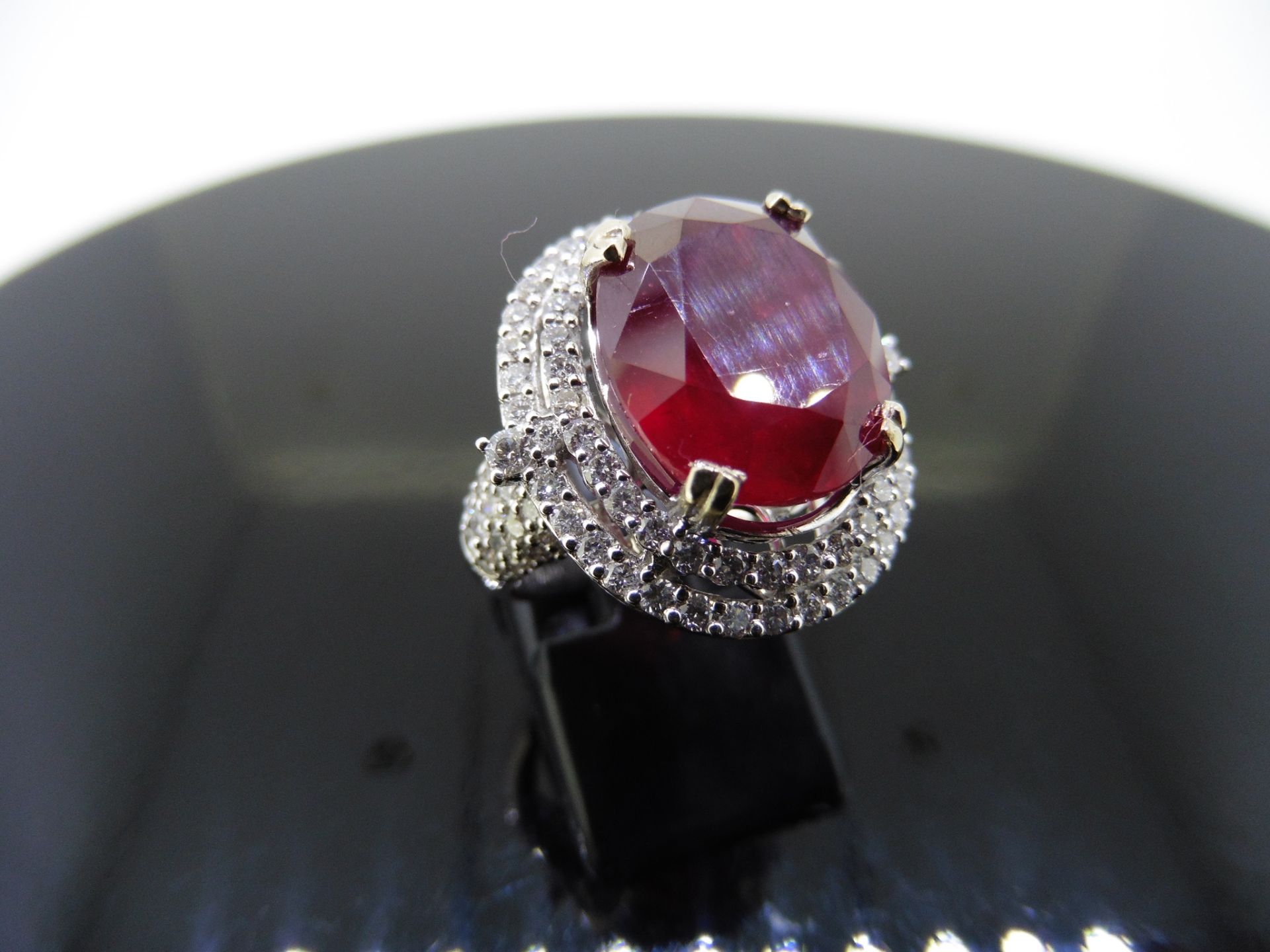12.30ct Ruby and diamond fancy dress ring. Oval cut ruby ( treated ) set in a four claw setting