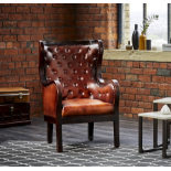 The Caff Curve armchair is covered with a beautiful mahogany leather and sits on a frame made of