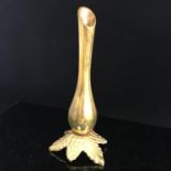 An Art Nouveau brass bud vase standing on a naturalistic leaf base, in good condition. Includes free