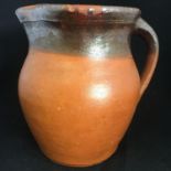 ANTIQUE REDWARE 19THC PRIMITIVE FOLK ART RUSTIC WATER JUG. Hand formed body and handle. The hammer