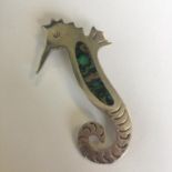 A white metal and shell brooch in the form of a seahorse. Stamped Alpace Mexico. Includes free UK