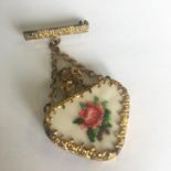 Miniature scent bottle in the form of a brooch with gilt metal and embroidered flower. In good