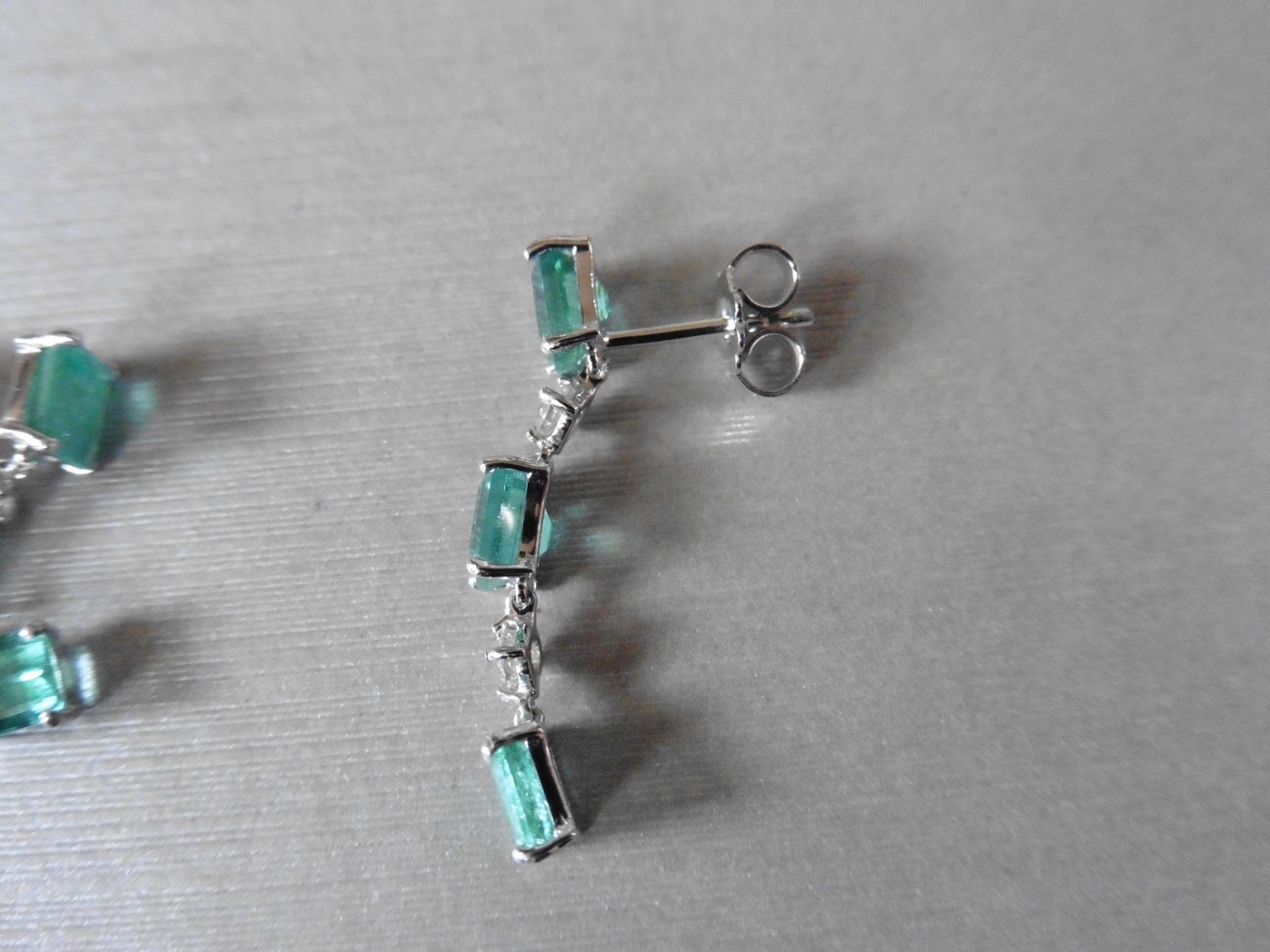2.50ct Emerald and 0.10ct diamond drop earrings. Each set with 3 emerald cut emeralds and 2 - Image 3 of 4