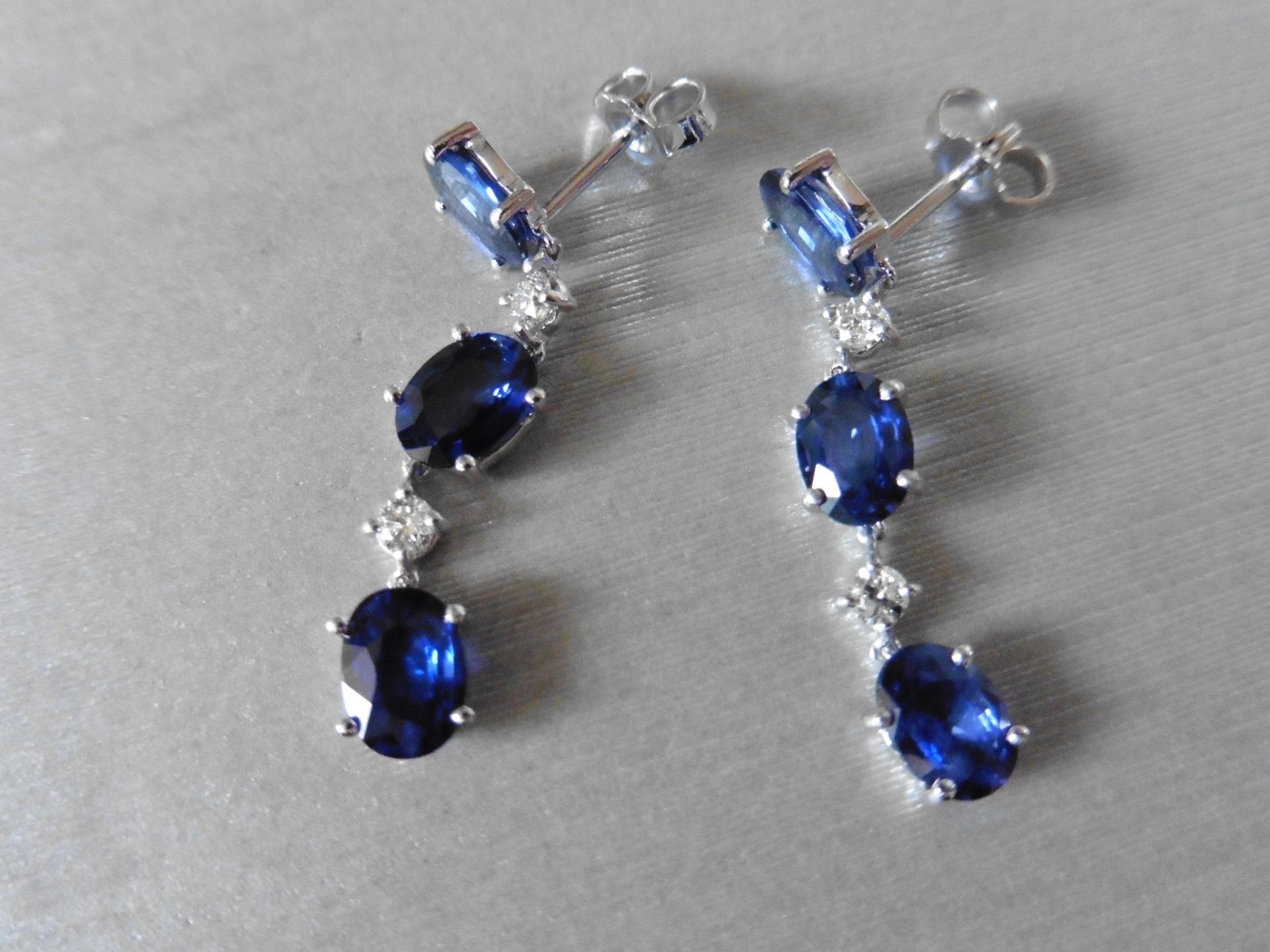 4.80ct sapphire and 0.12ct diamond drop earrings. Each set with 3 oval cut sapphires and 2 brilliant - Image 3 of 4