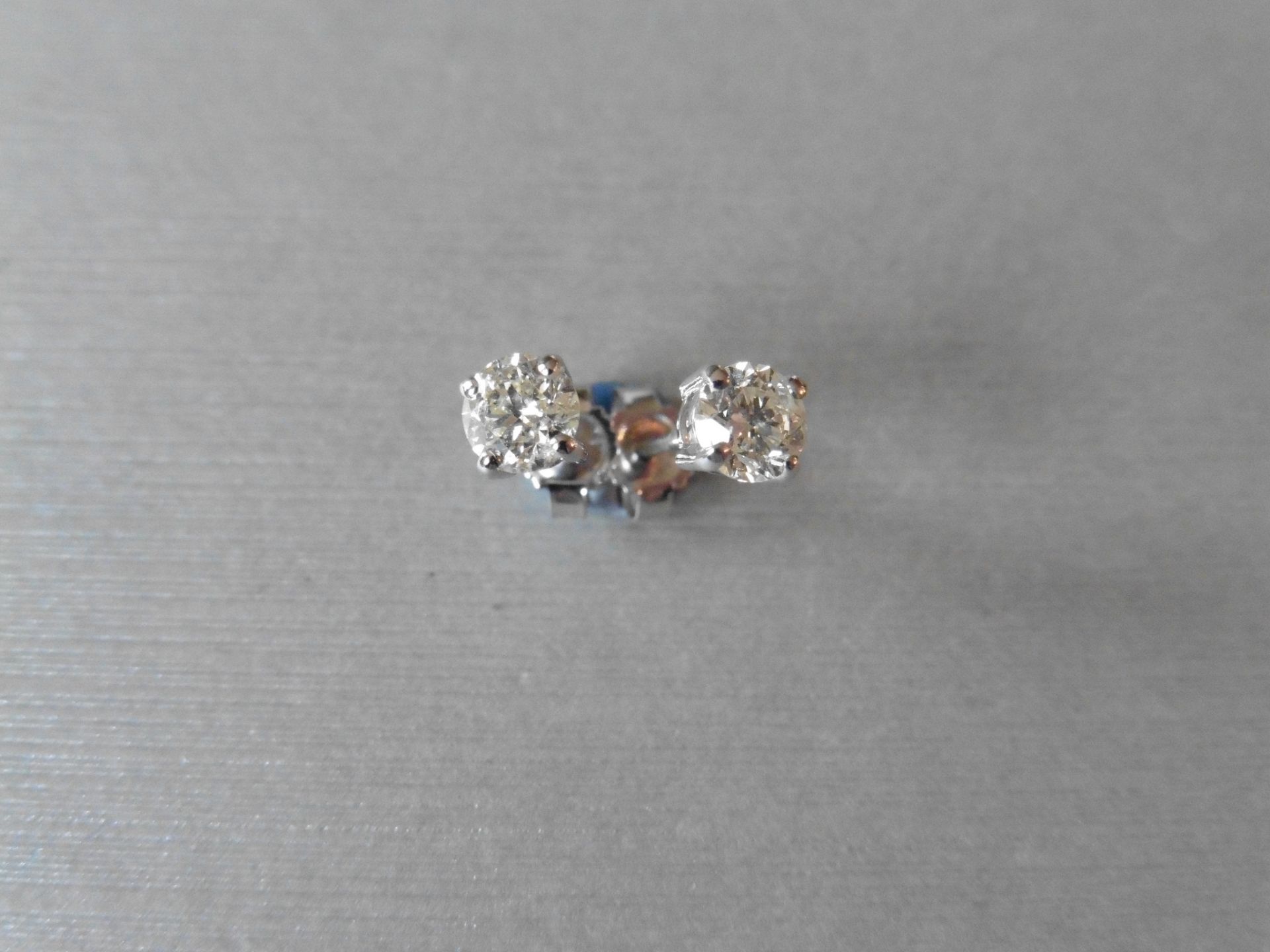 0.80ct Diamond solitaire earrings set with brilliant cut diamonds, I/J colour SI2 clarity. Four claw