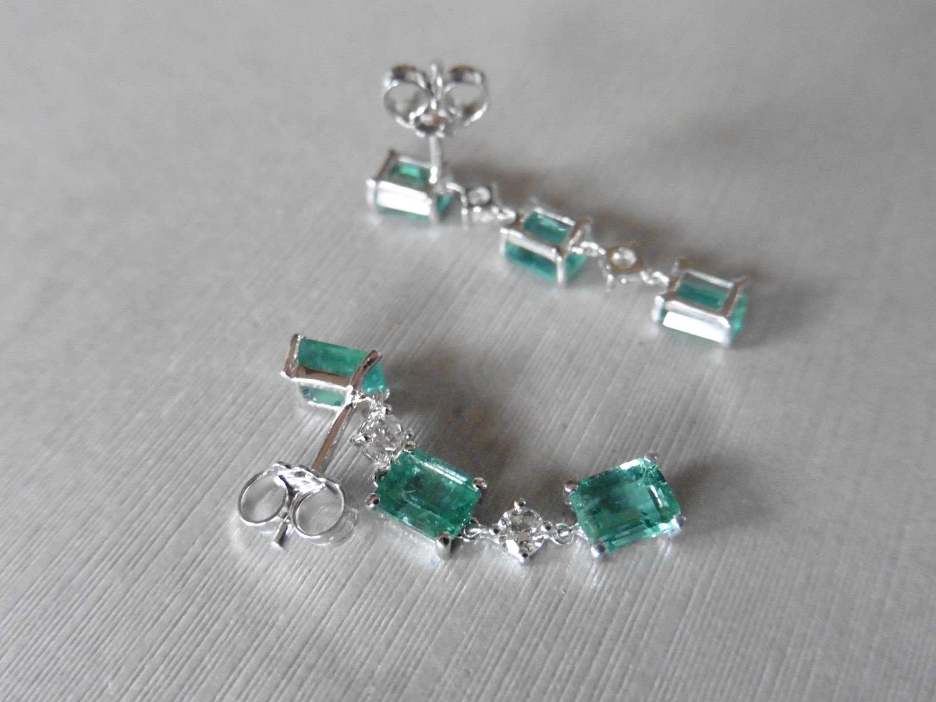 2.50ct Emerald and 0.10ct diamond drop earrings. Each set with 3 emerald cut emeralds and 2 - Image 2 of 4