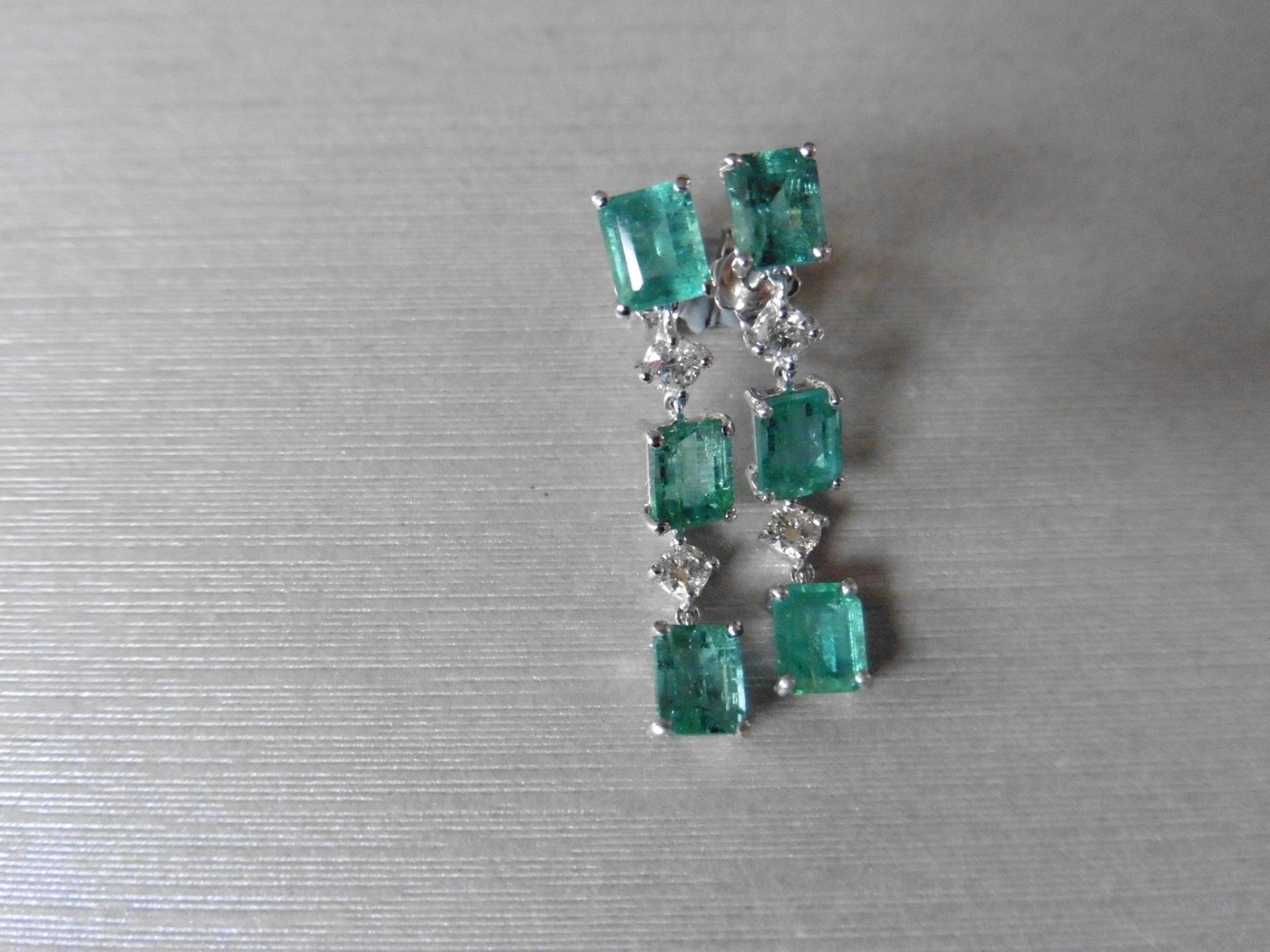 2.50ct Emerald and 0.10ct diamond drop earrings. Each set with 3 emerald cut emeralds and 2