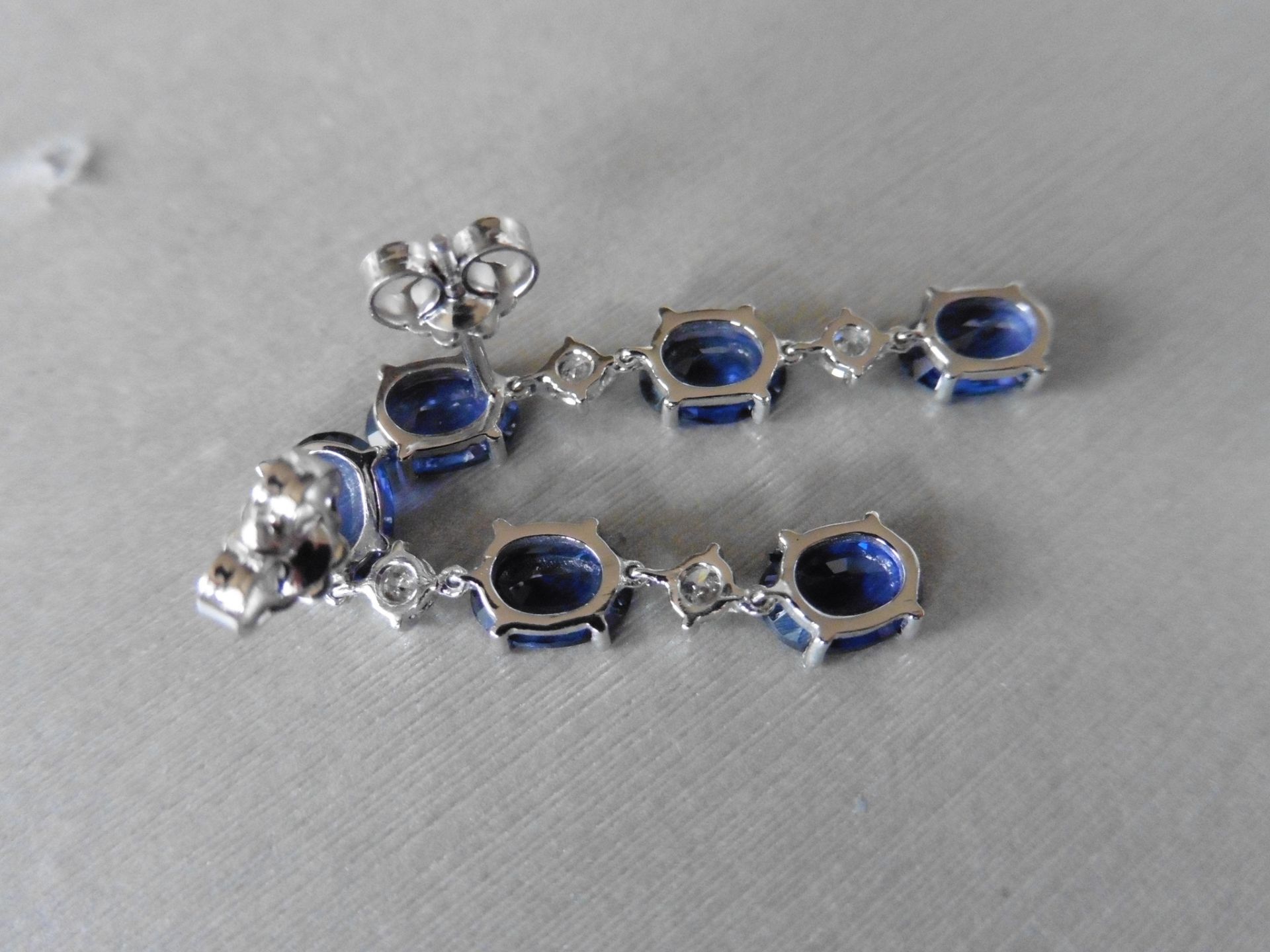 4.80ct sapphire and 0.12ct diamond drop earrings. Each set with 3 oval cut sapphires and 2 brilliant - Image 2 of 4