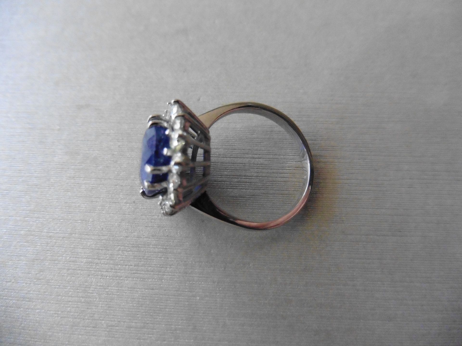 6ct sapphire and diamond cluster ring. Oval cut colour treated sapphire surrounded by brilliant - Image 2 of 4