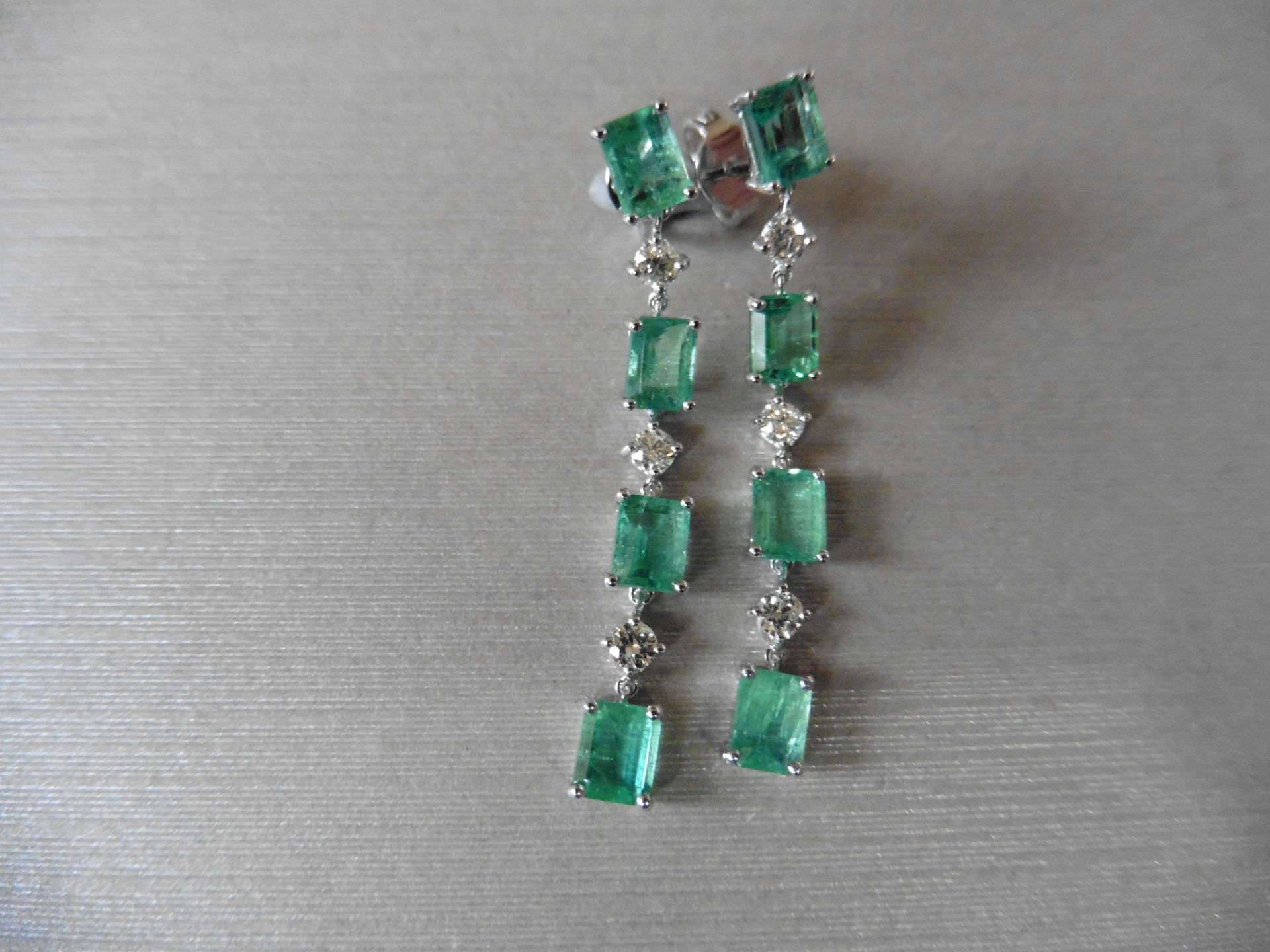 3ct emerald and diamond drop earrings. Each set with 4 emerald cut emeralds and 3 brilliant cut