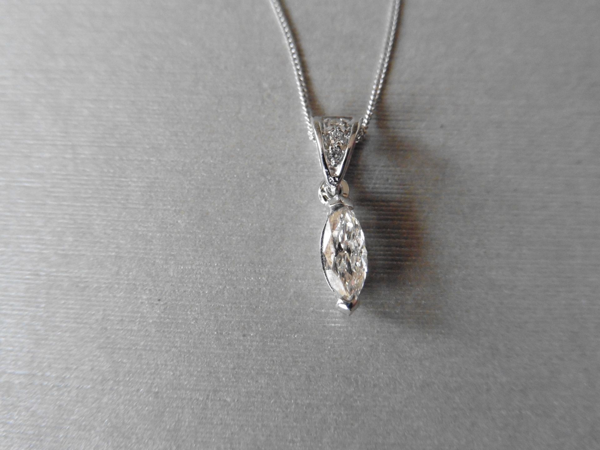 0.50ct diamond solitaire pendant set with a marquise shaped diamond, H colour, VS1 clarity. 2 claw