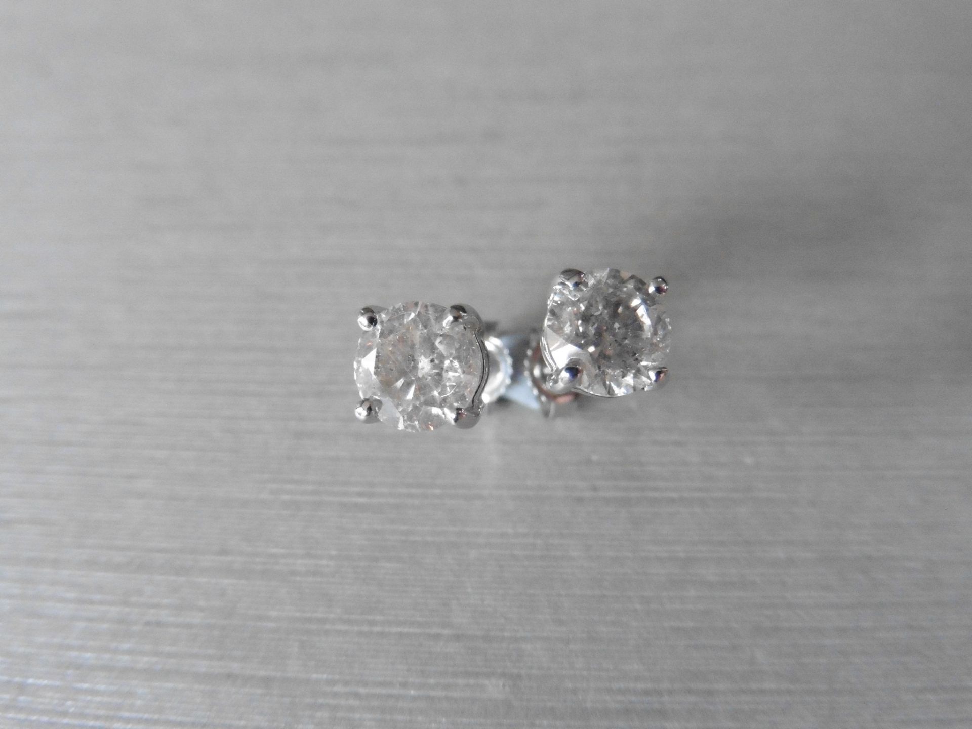 2.00ct Solitaire diamond stud earrings set with brilliant cut diamonds which have been enhanced. H/I