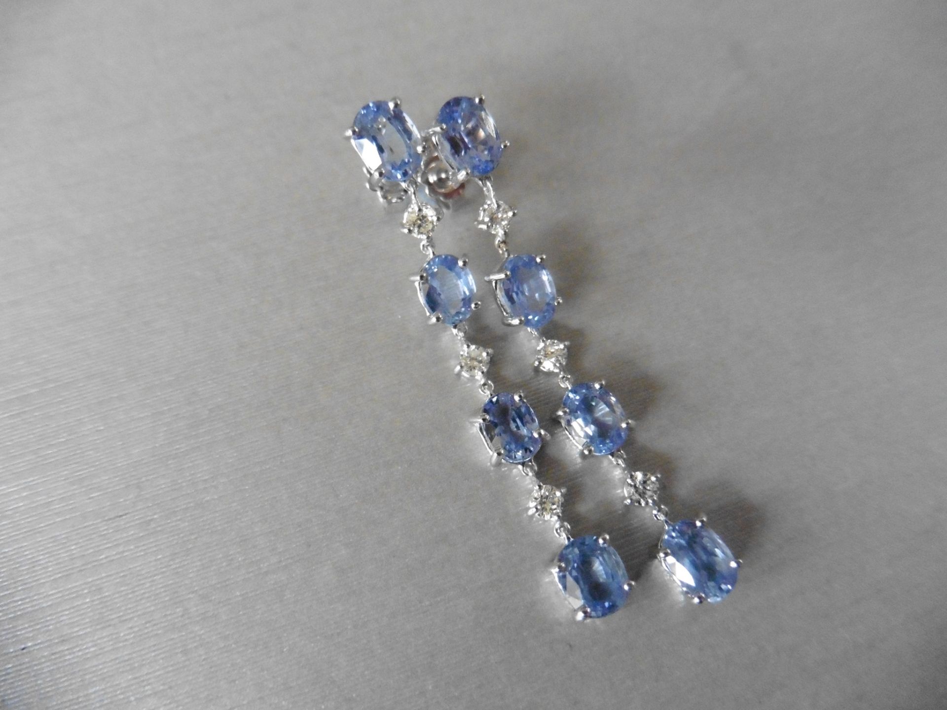 3ct ceylon sapphire and diamond drop earrings. Each set with 4 oval cut sapphires and 3 brilliant