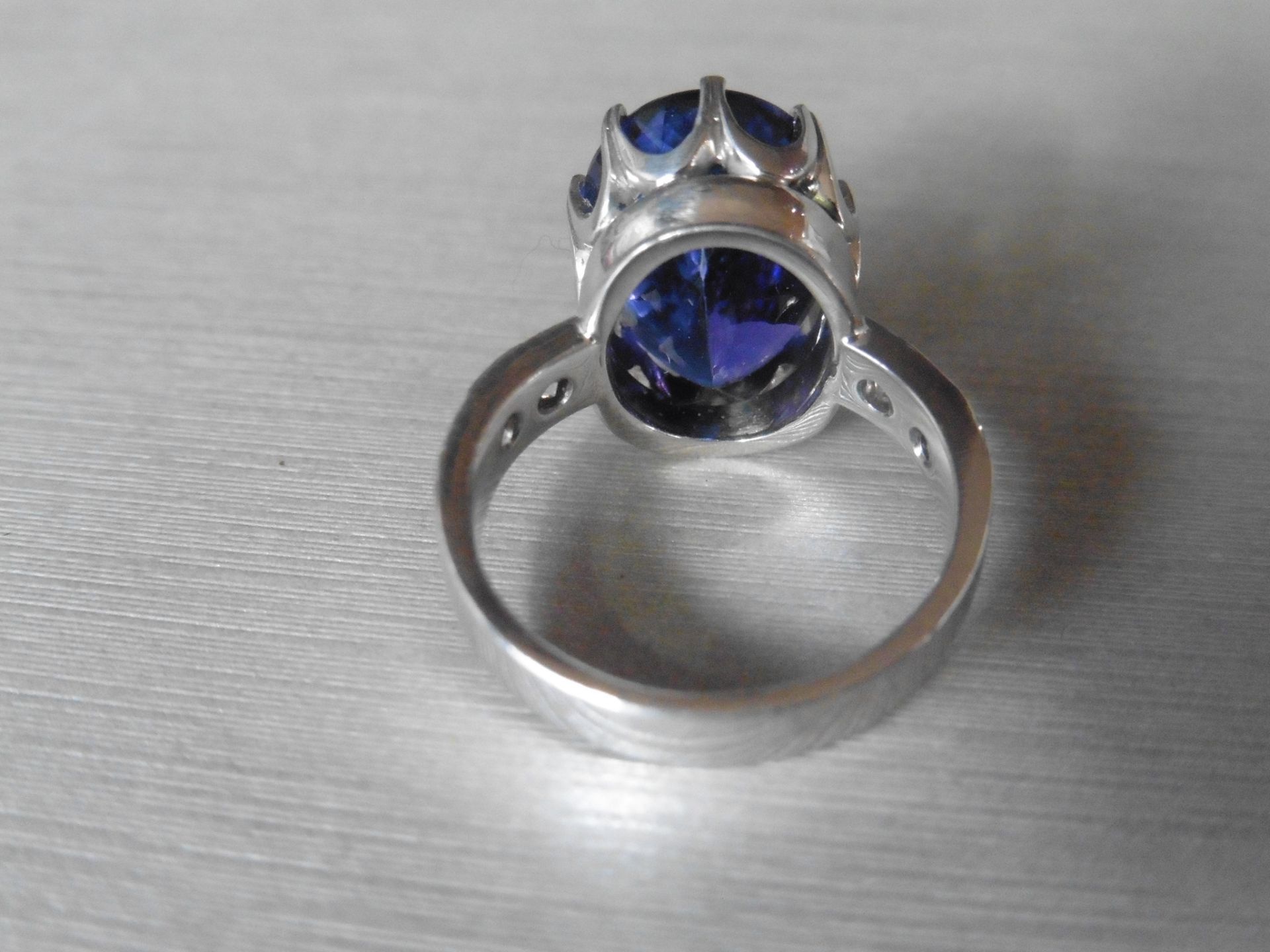 8.85ct tanzanite and diamond dress ring. Oval cut AAAA tanzanite secured in a 10 claw basket setting - Image 3 of 5