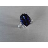 8.85ct tanzanite and diamond dress ring. Oval cut AAAA tanzanite secured in a 10 claw basket setting