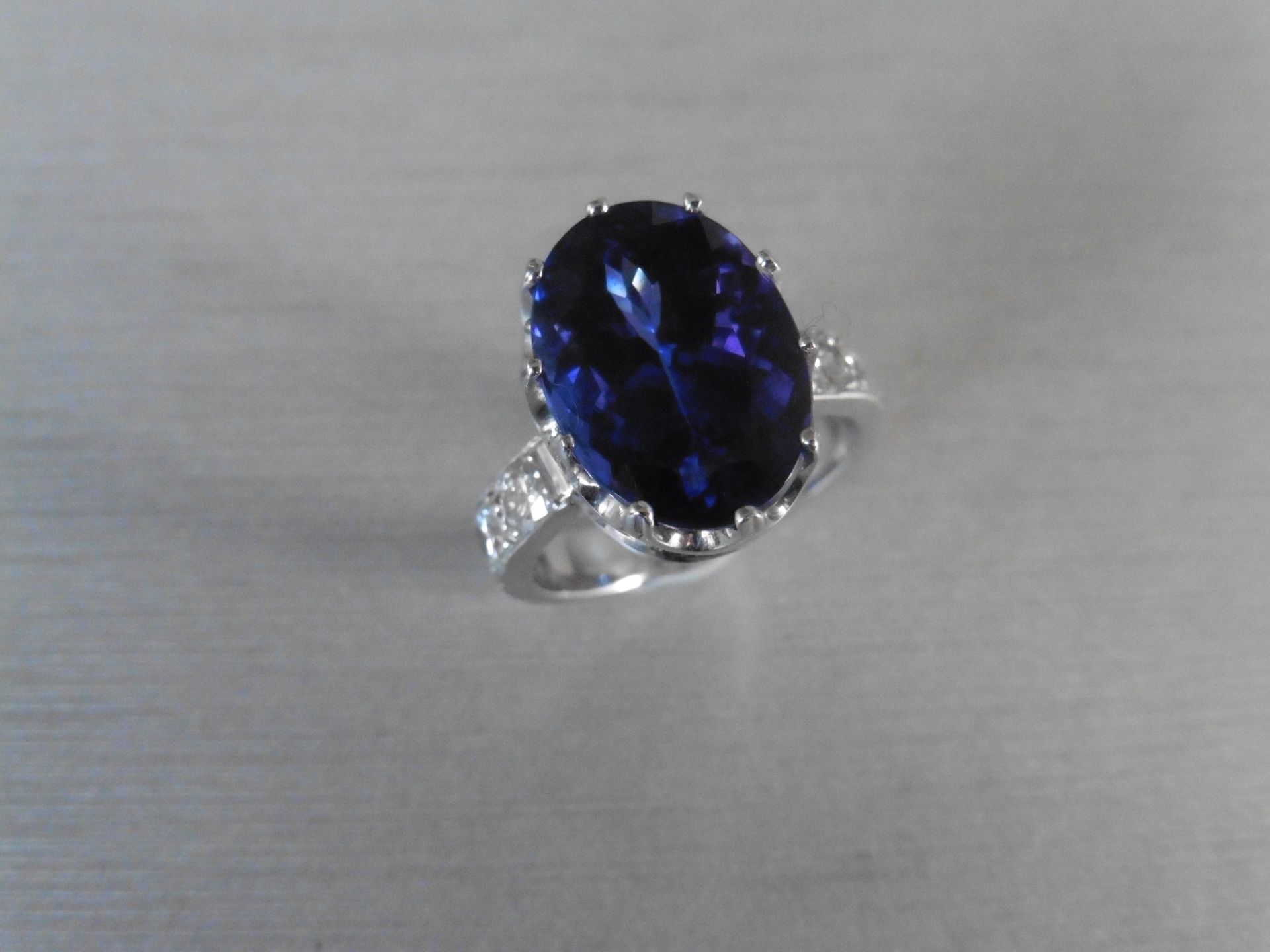 8.85ct tanzanite and diamond dress ring. Oval cut AAAA tanzanite secured in a 10 claw basket setting