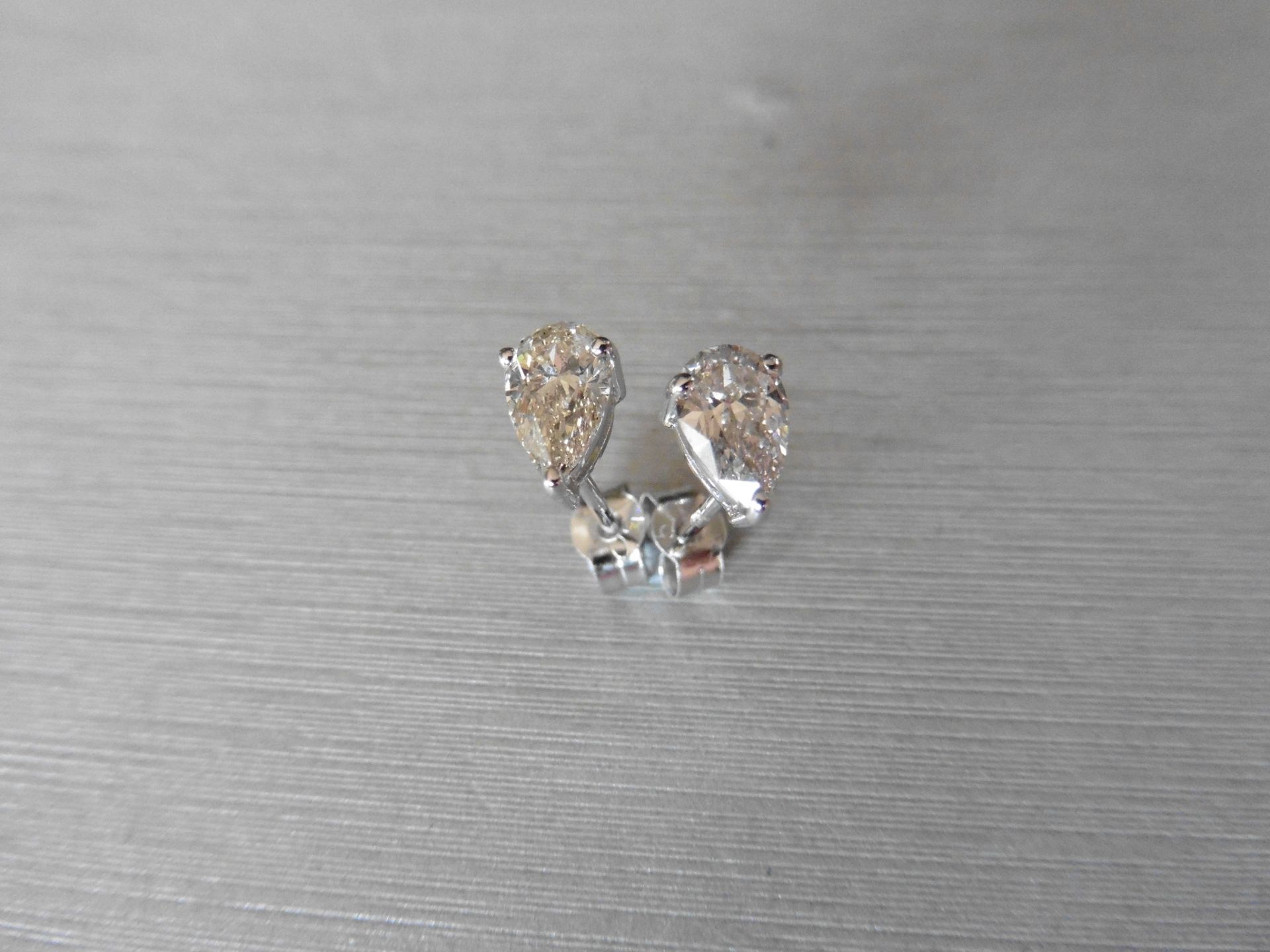 1.40ct Diamond solitaire earrings set with pear shaped diamonds, I colour VS2 clarity. Three claw