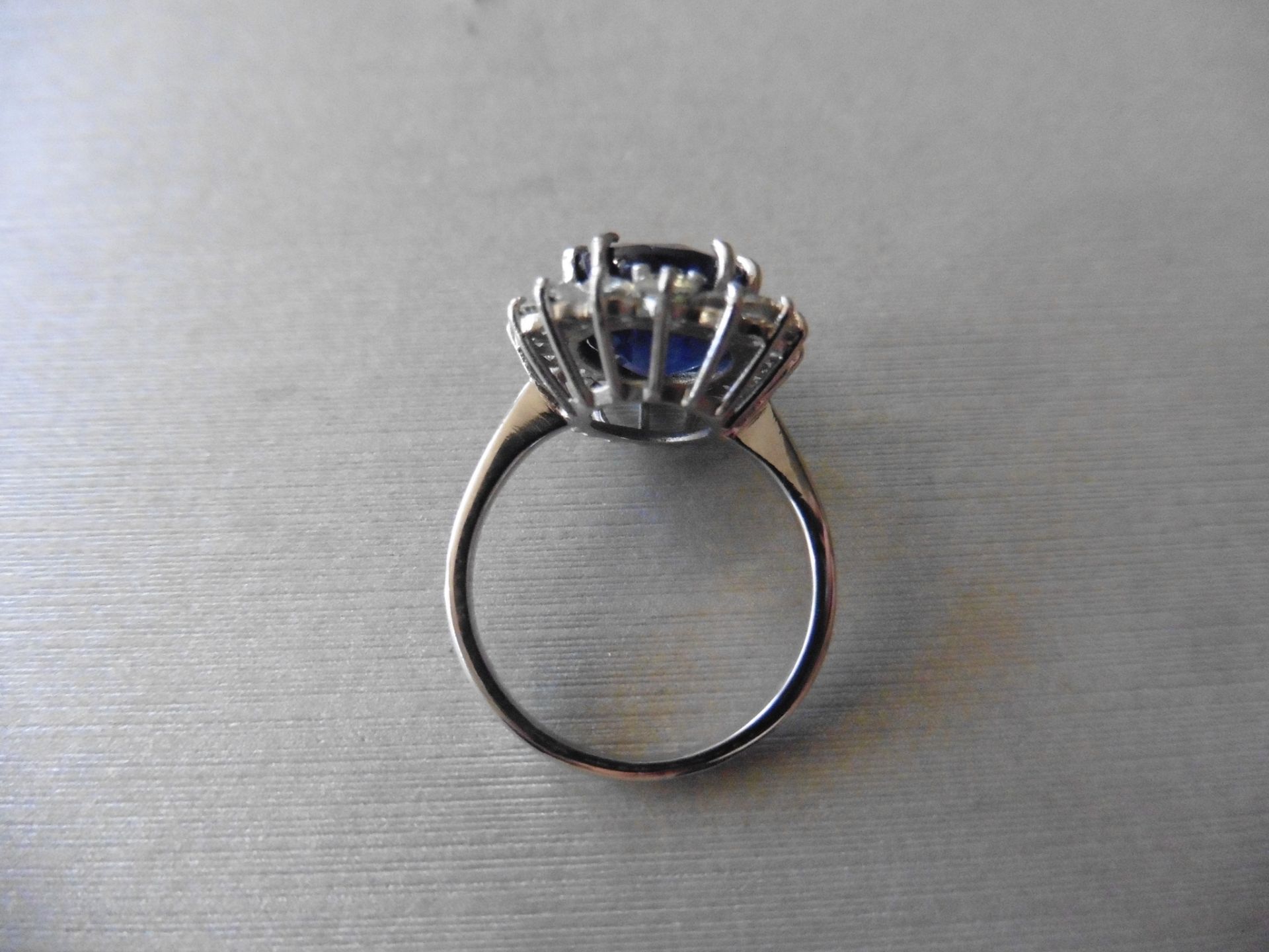 6ct sapphire and diamond cluster ring. Oval cut colour treated sapphire surrounded by brilliant - Image 3 of 4