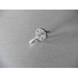 0.84ct oval diamond set solitaire ring. Centre diamond G/H colour, Si3 clarity. Halo setting of