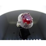 12.30ct Ruby and diamond fancy dress ring. Oval cut ruby ( treated ) set in a four claw setting