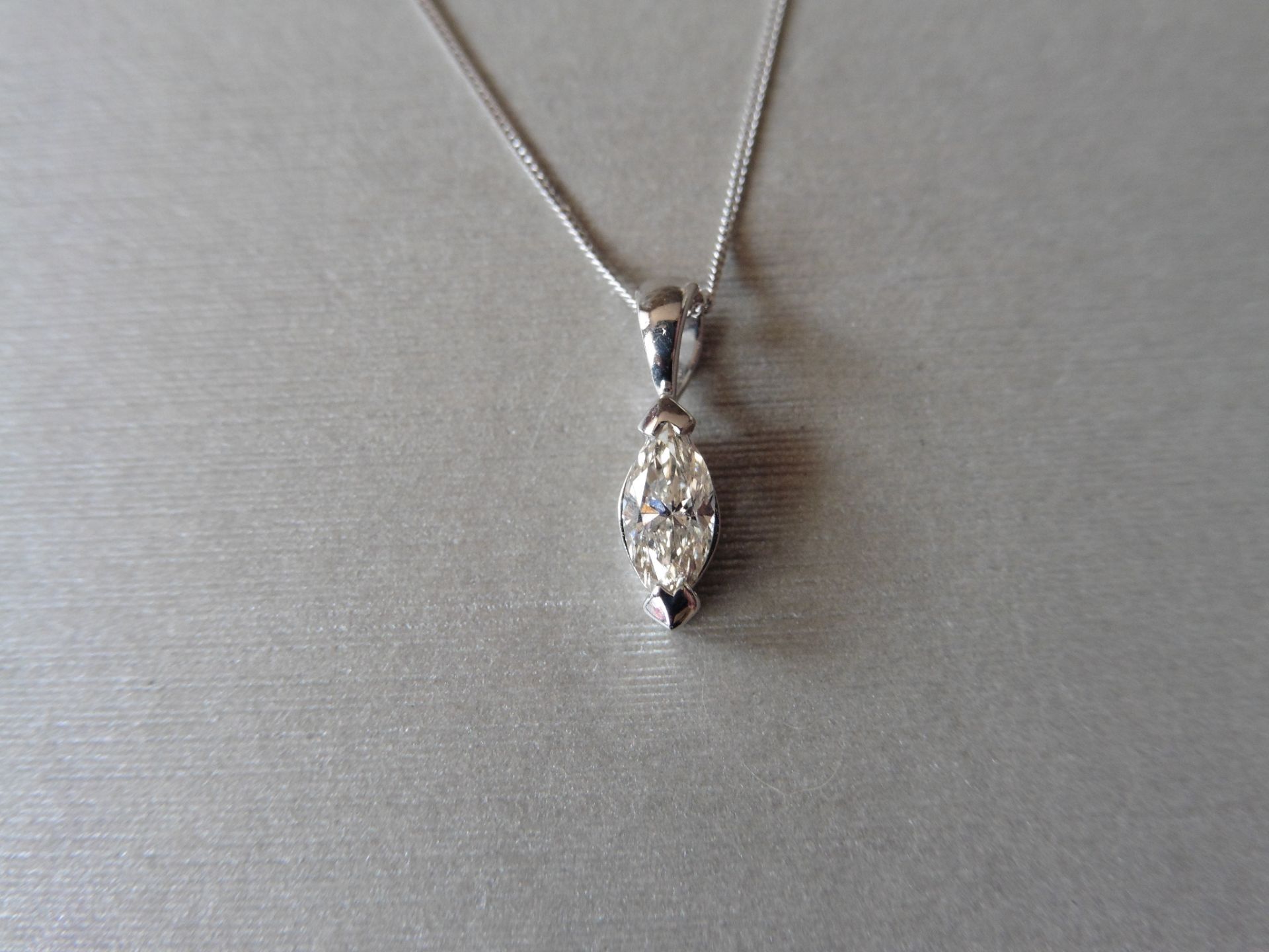 0.70ct diamond solitaire pendant set with a marquise shaped diamond, I colour, VS2 clarity. 2 claw