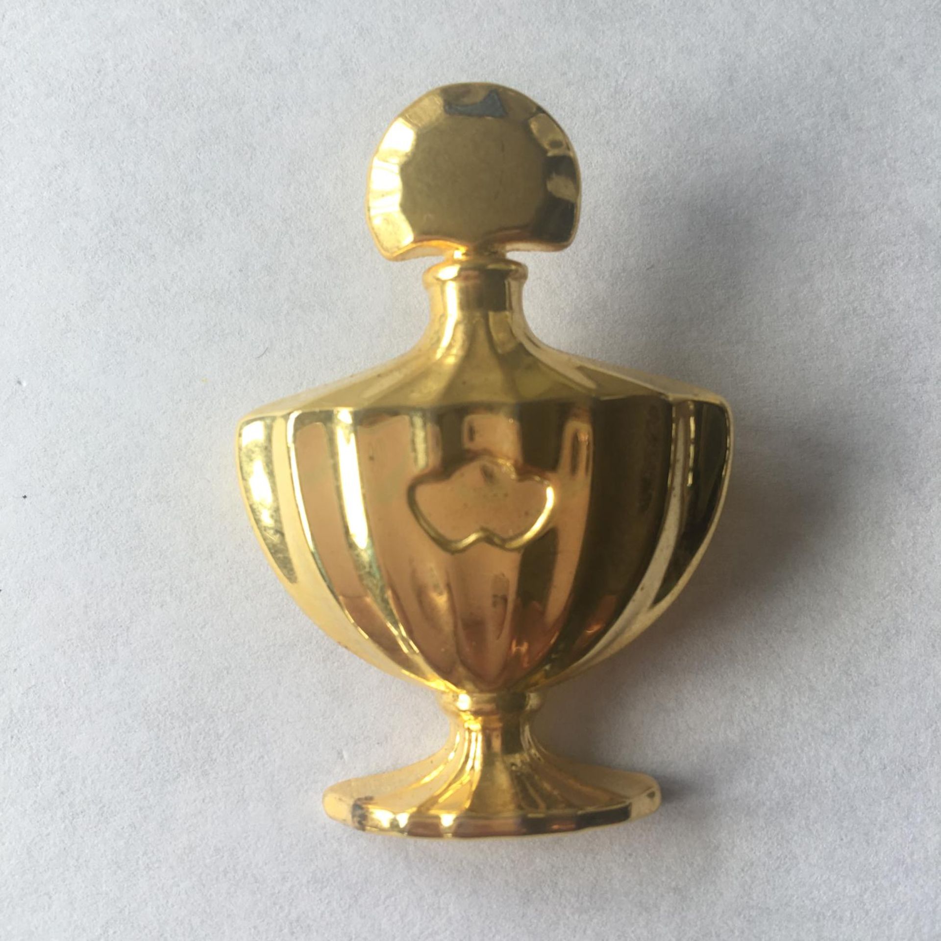 Guerlain Paris pin brooch in the form of a perfume bottle. Includes free UK delivery.