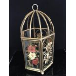 Glass panelled hanging lantern cage having dried flower decoration within the panels, leaf and