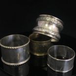 Group of 4 various vintage napkin rings to include one with Chinese Character marks, one yellow