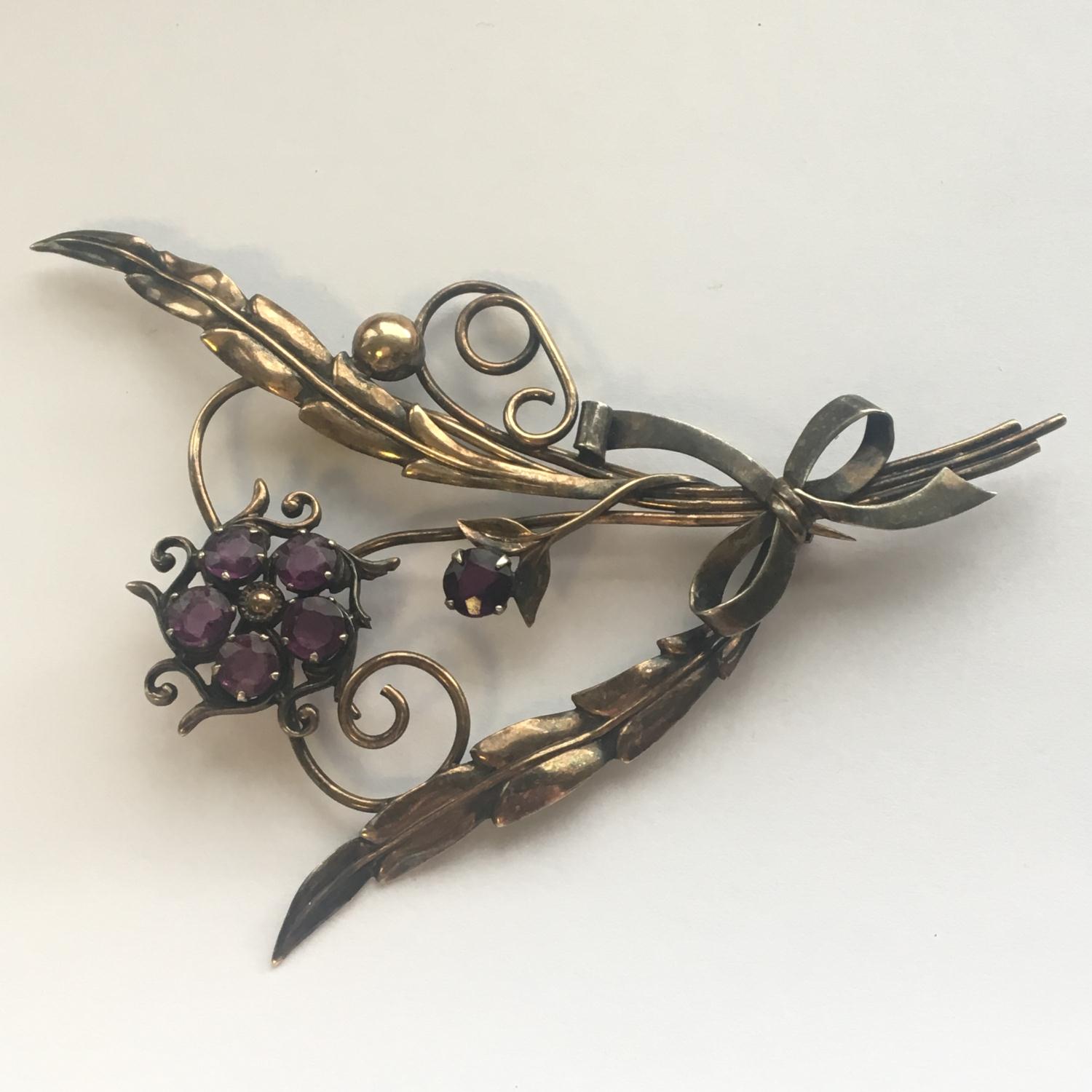 Large vintage brooch set with purple stones. Measures 10cm across. Includes free UK delivery.