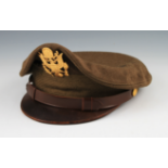 A USAAF GREEN PEAKED CAP WITH CAP BADGE TO FRONT