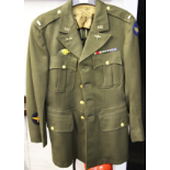 A US TUNIC WITH MEDAL BARS PLUS CLOTH BADGES TO SHOULDER AND BODY, DATE WORN.