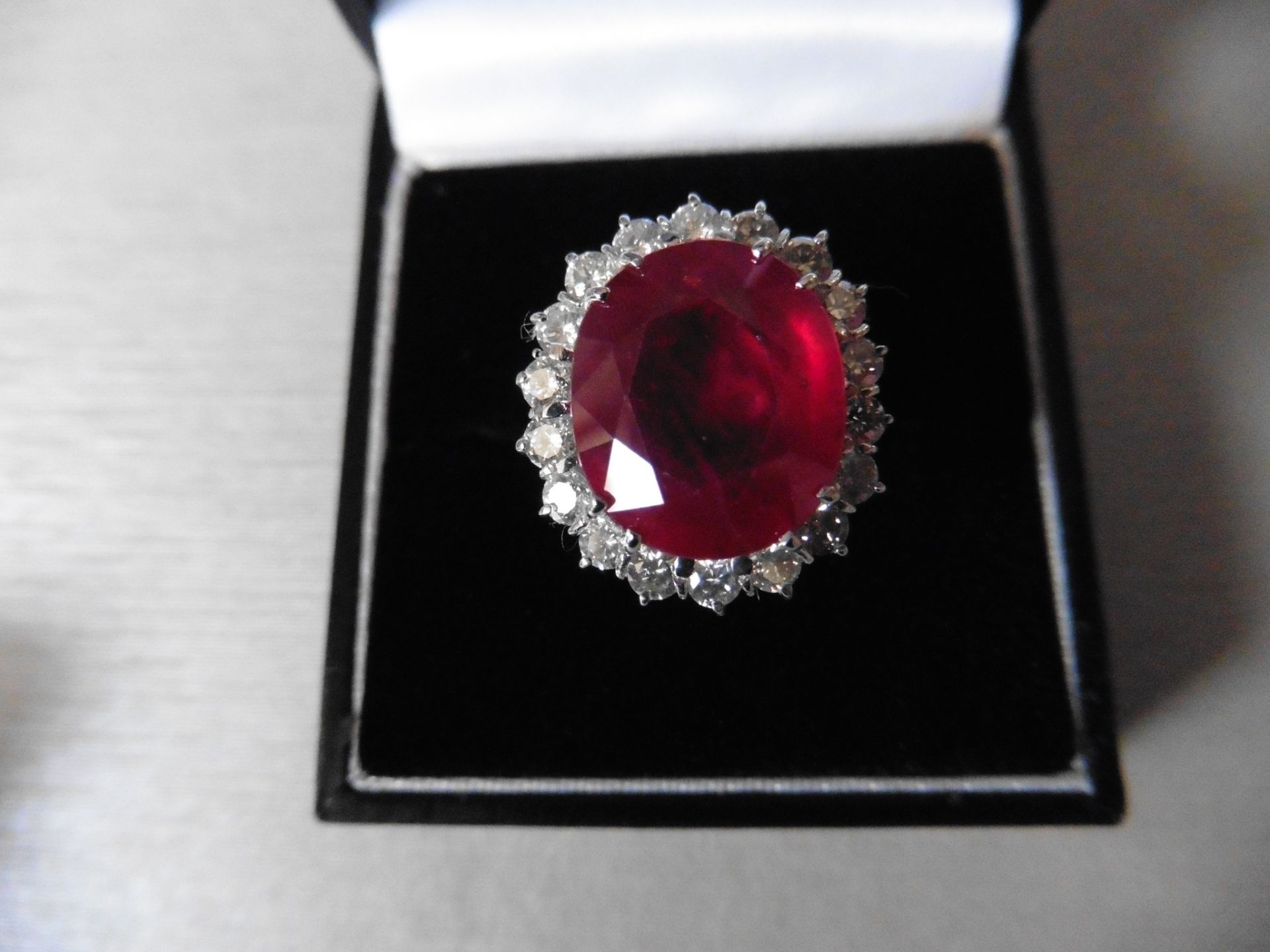 8ct ruby and diamond cluster ring. Oval cut ruby in the centre surrounded by brilliant cut diamonds, - Image 4 of 4