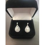 2.04ct diamond drop earrings. Each set with a certificated pear shaped diamond with a halo
