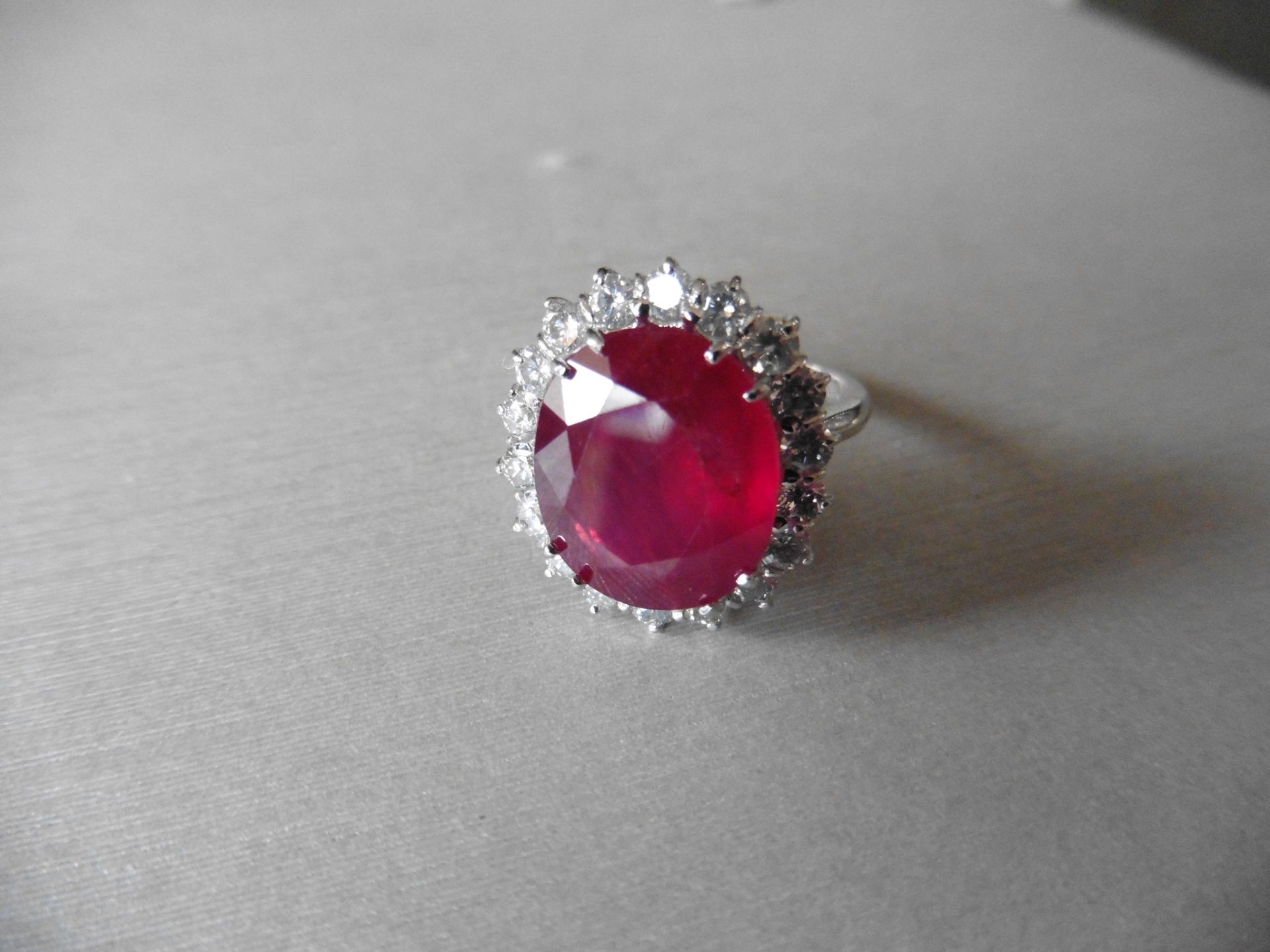 8ct ruby and diamond cluster ring. Oval cut ruby in the centre surrounded by brilliant cut diamonds, - Image 3 of 4