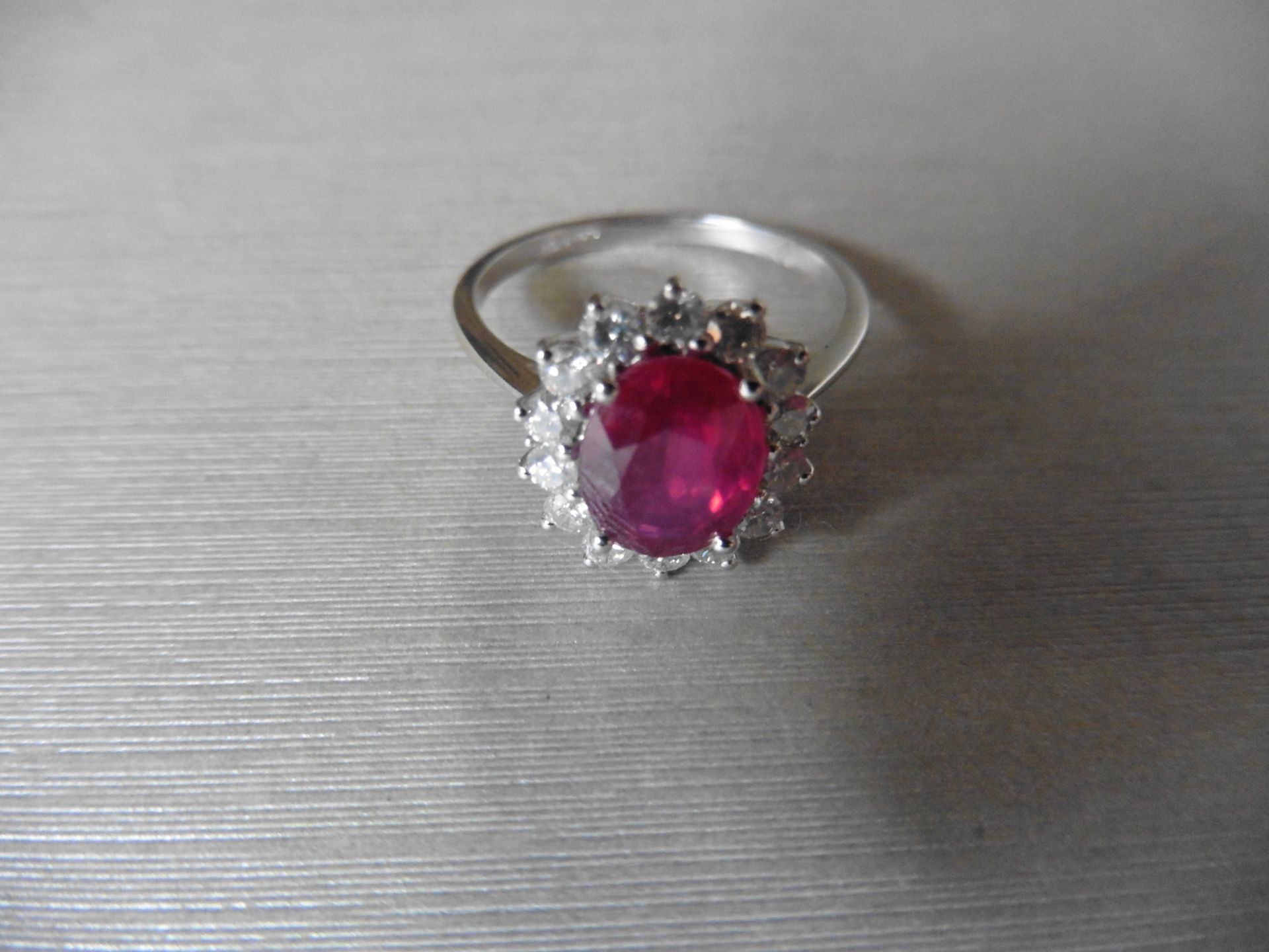 2.50ct Ruby and diamond cluster ring set with an oval cut ( glass filled )ruby which is surrounded - Image 3 of 3
