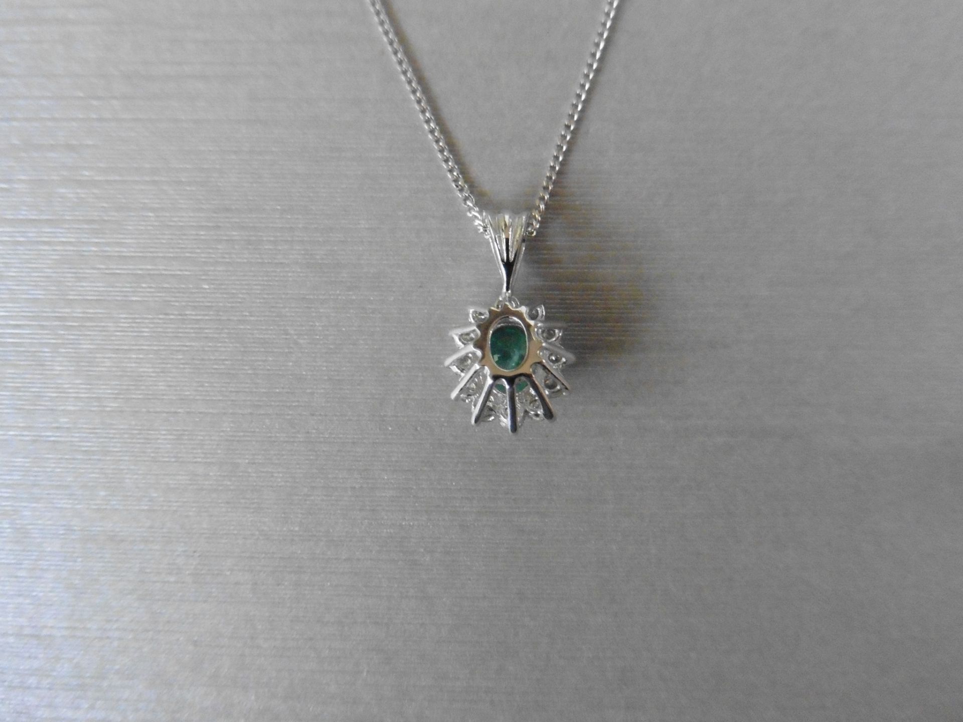 0.80ct emerald and diamond cluster style pendant.  Oval cut treated emerald with 12 small - Image 2 of 3