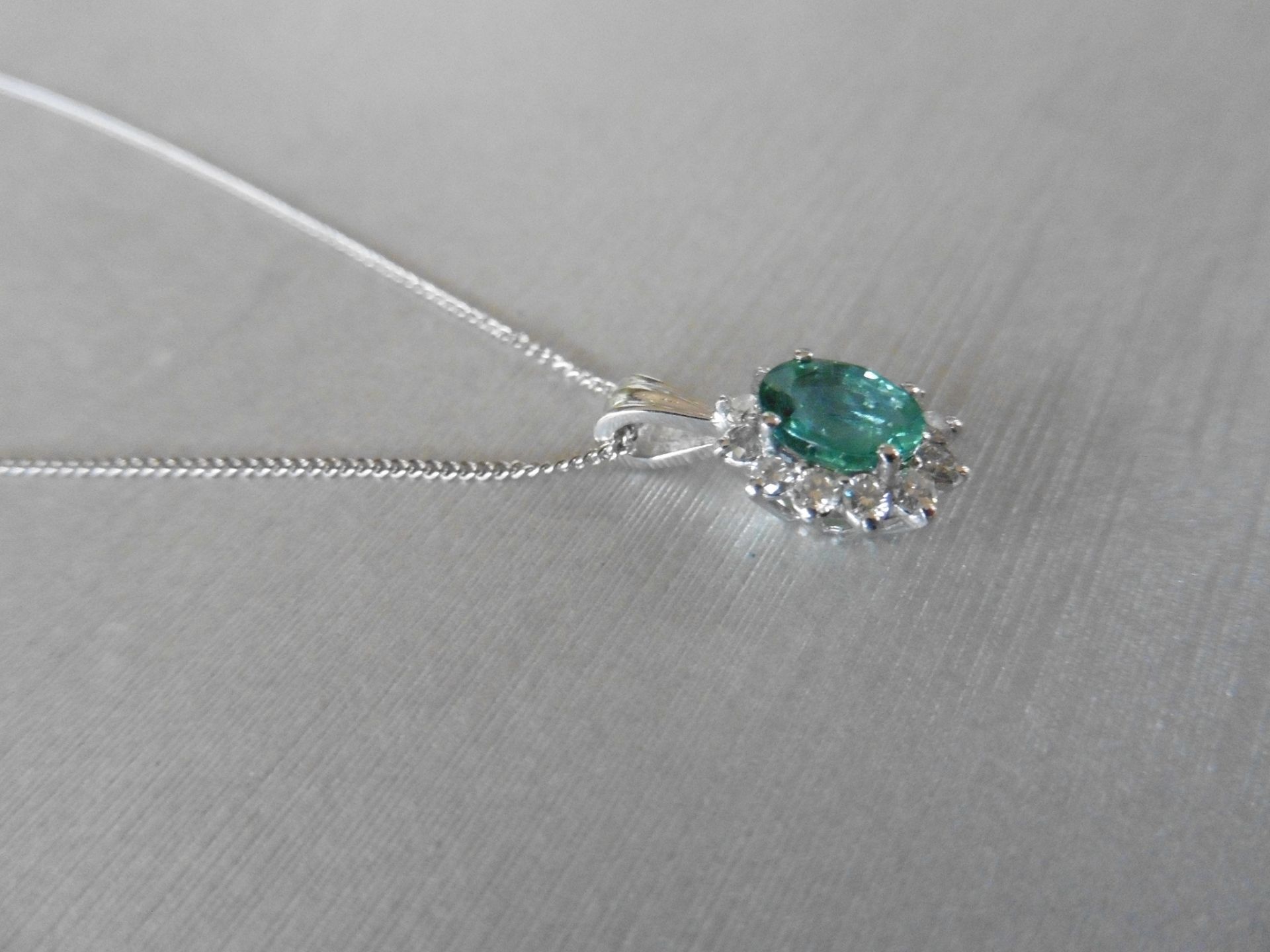 0.80ct emerald and diamond cluster style pendant.  Oval cut treated emerald with 12 small - Image 3 of 3