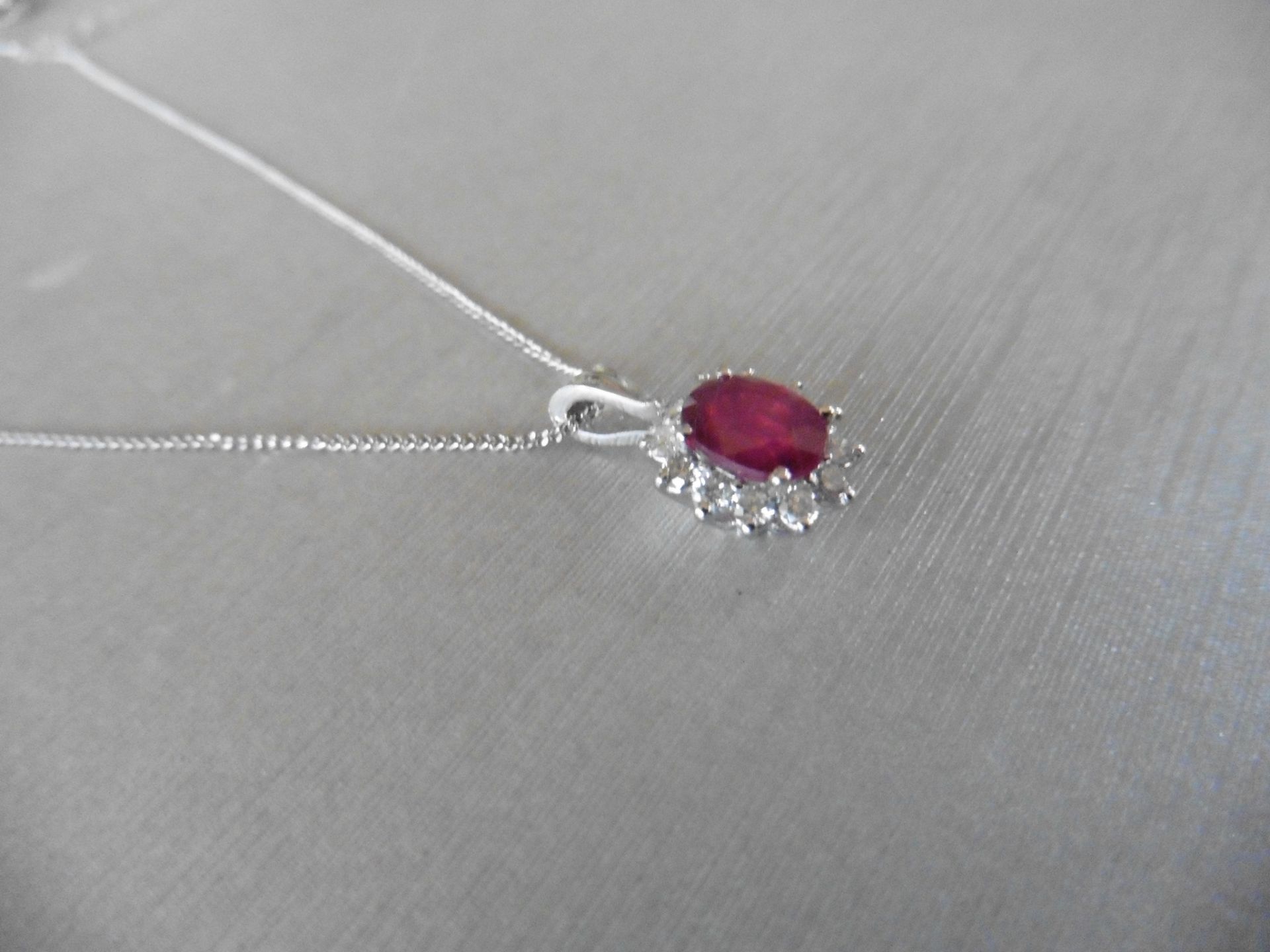 0.80ct ruby and diamond cluster style pendant.  Oval cut ( glass filled ) treated ruby with 12 small - Image 2 of 3