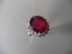 8ct ruby and diamond cluster ring. Oval cut ruby in the centre surrounded by brilliant cut diamonds,