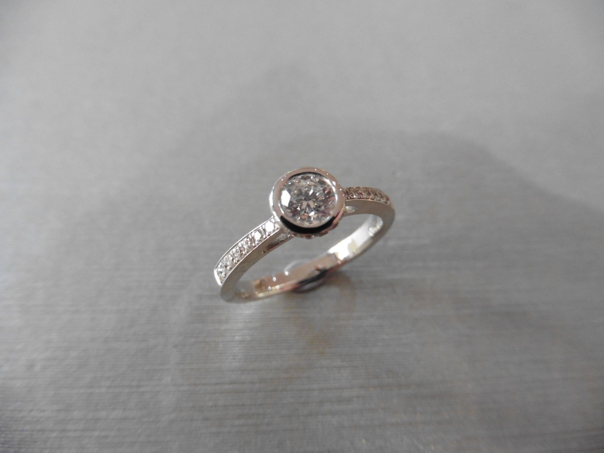 0.41ct 18ct white gold diamond set solitaire ring with a Brilliant cut diamond secured in a rub over