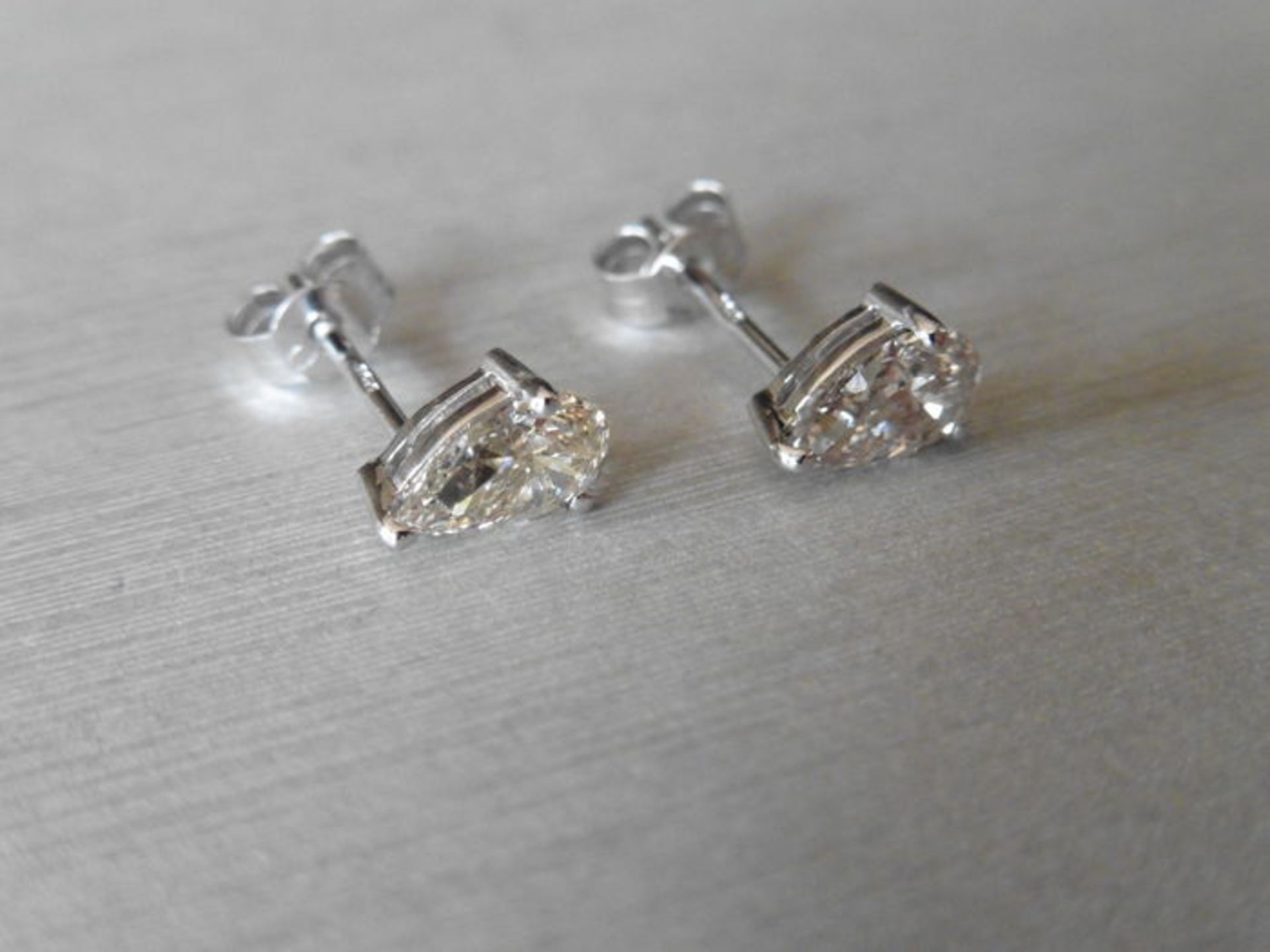 0.70ct diamond earrings set with pear shaped diamonds, I/J colour, si2 clarity. 3 claw setting in - Image 3 of 3