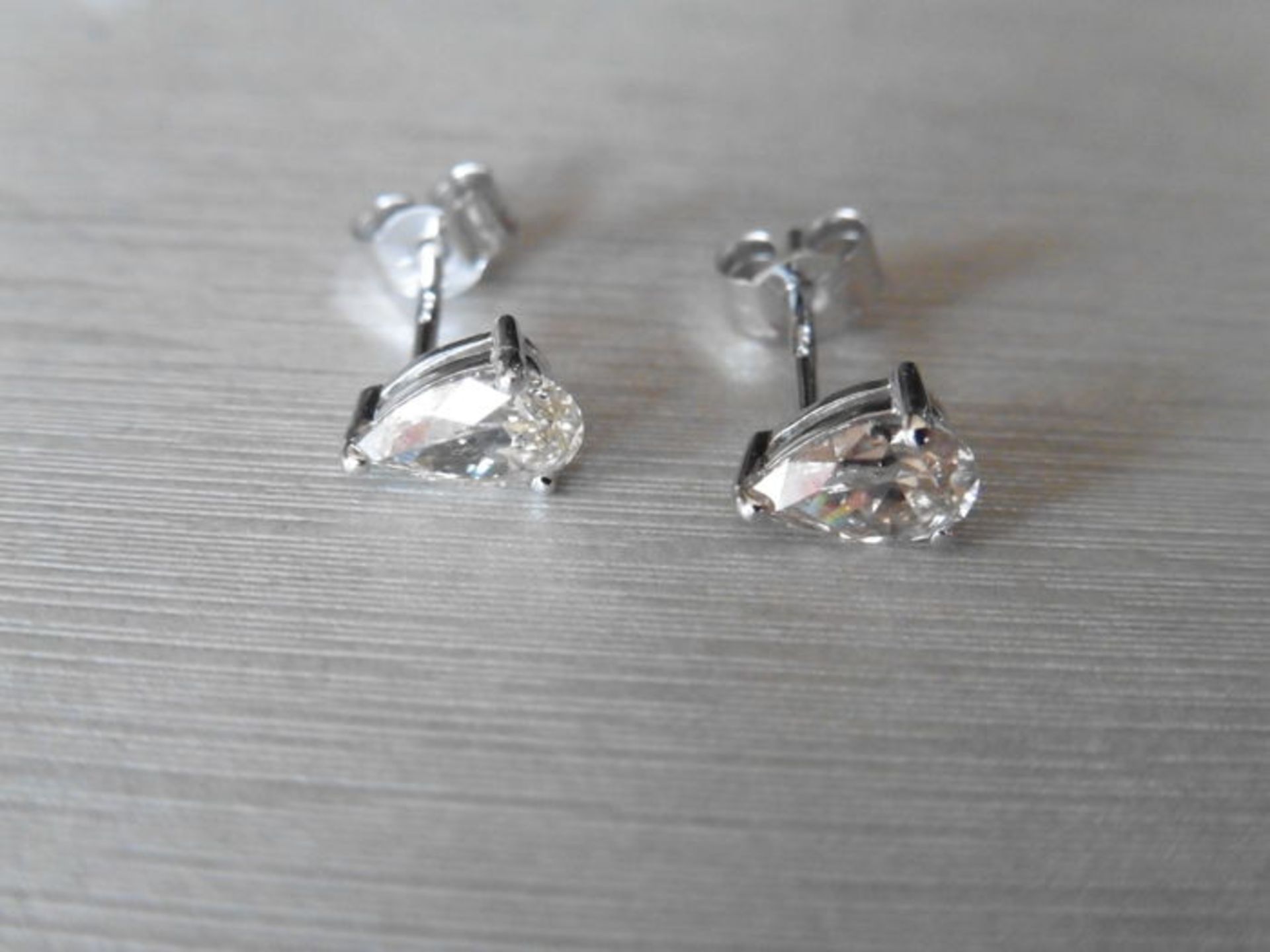 0.70ct diamond earrings set with pear shaped diamonds, I/J colour, si2 clarity. 3 claw setting in - Image 2 of 3